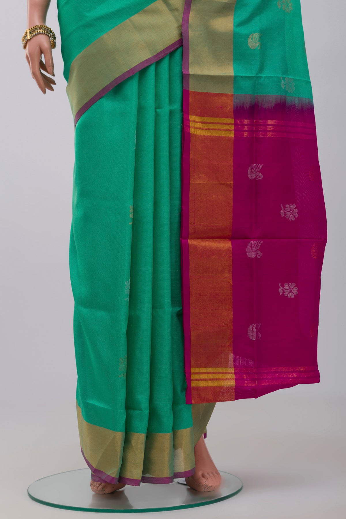 Pleats and pallu of Green Uppada Silk Saree with Zari Butta on the body and Zari Border. 