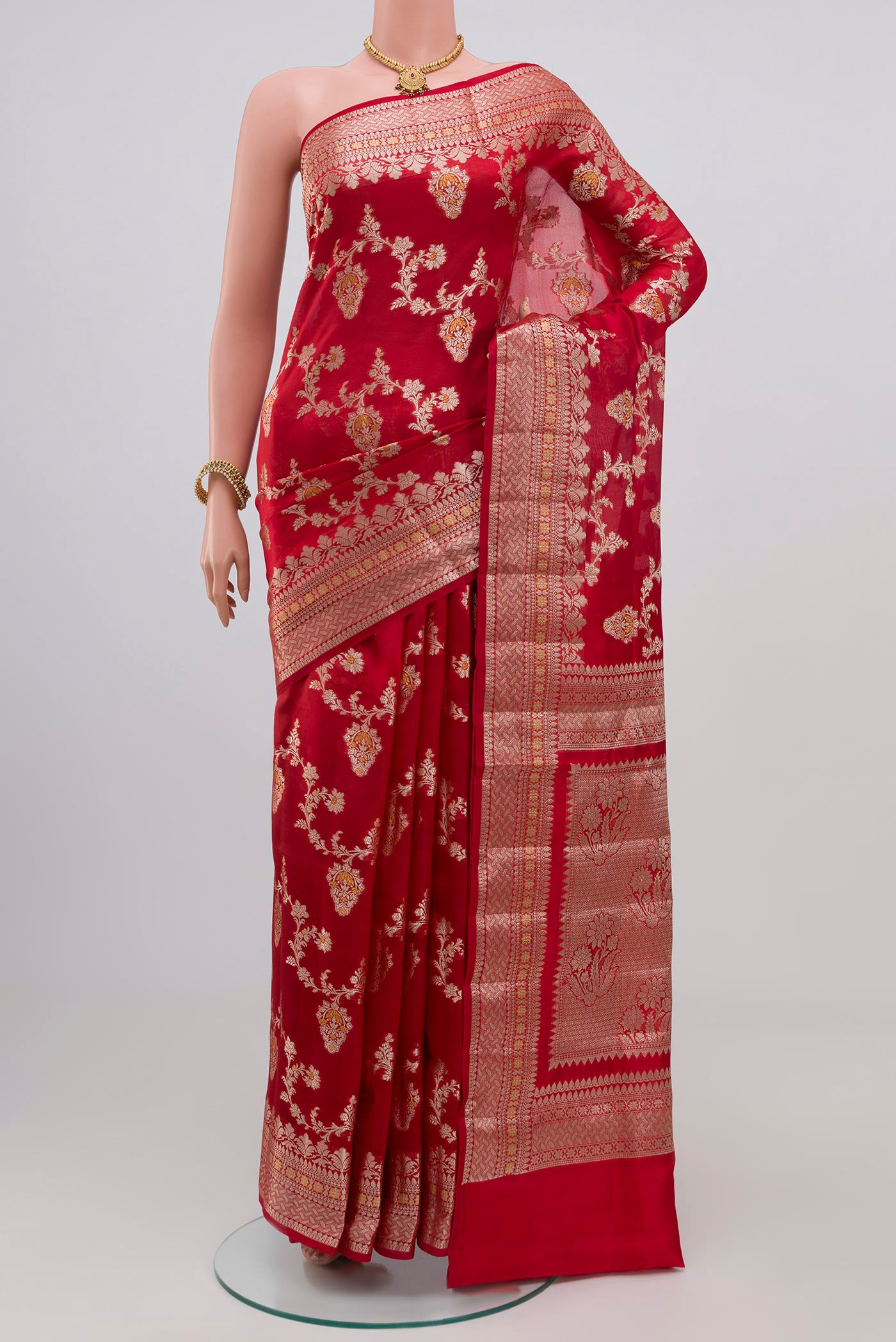 Red Raw Silk Saree with Zari Butta on the body and Zari Border.  displayed on a mannequin