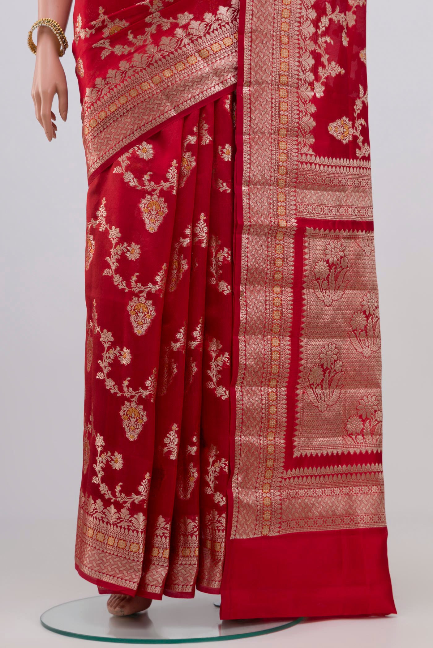 Pleats and pallu of Red Raw Silk Saree with Zari Butta on the body and Zari Border. 