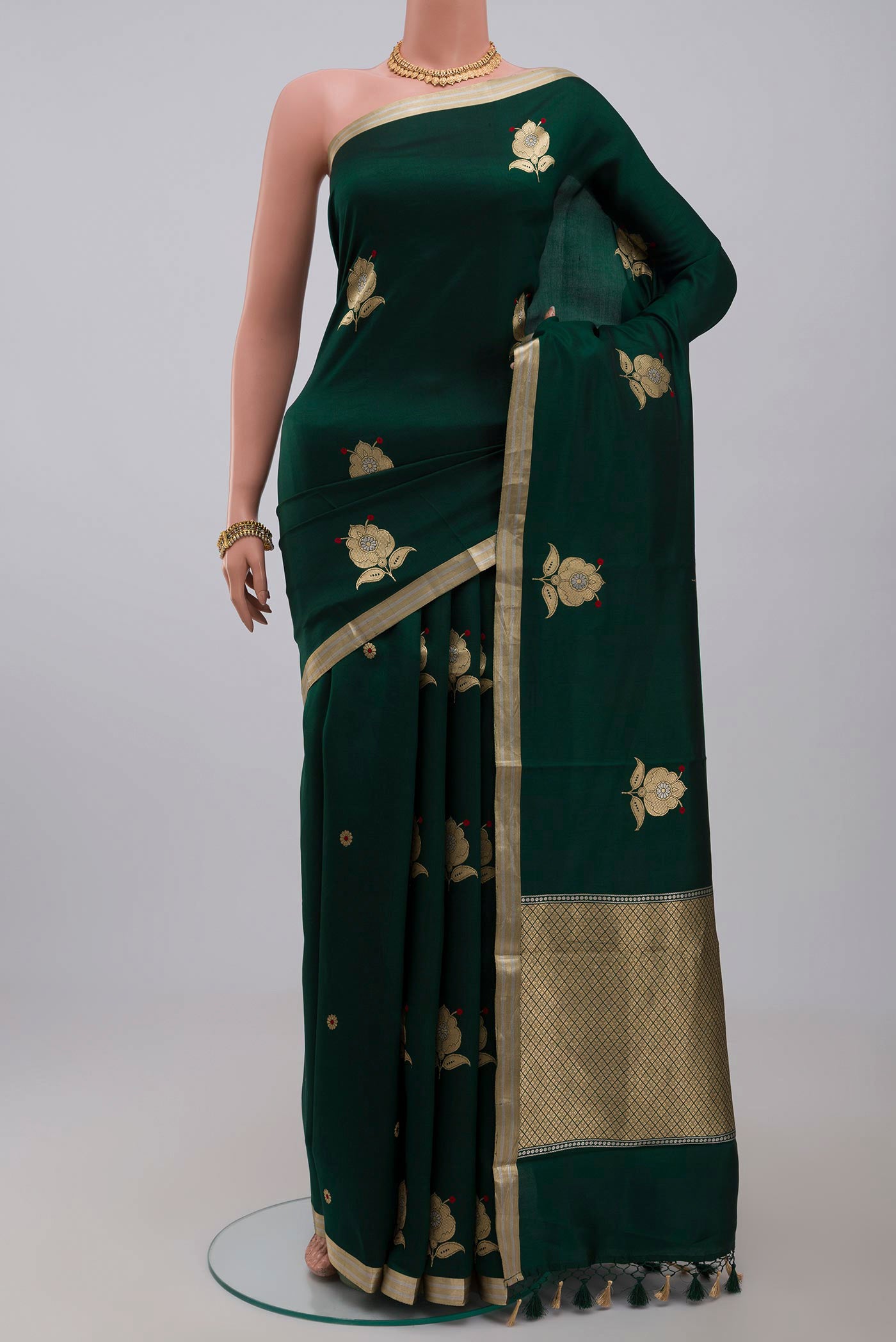 Green Banarasi Katan Silk Saree with Zari Butta on the body and Zari Border.  displayed on a mannequin