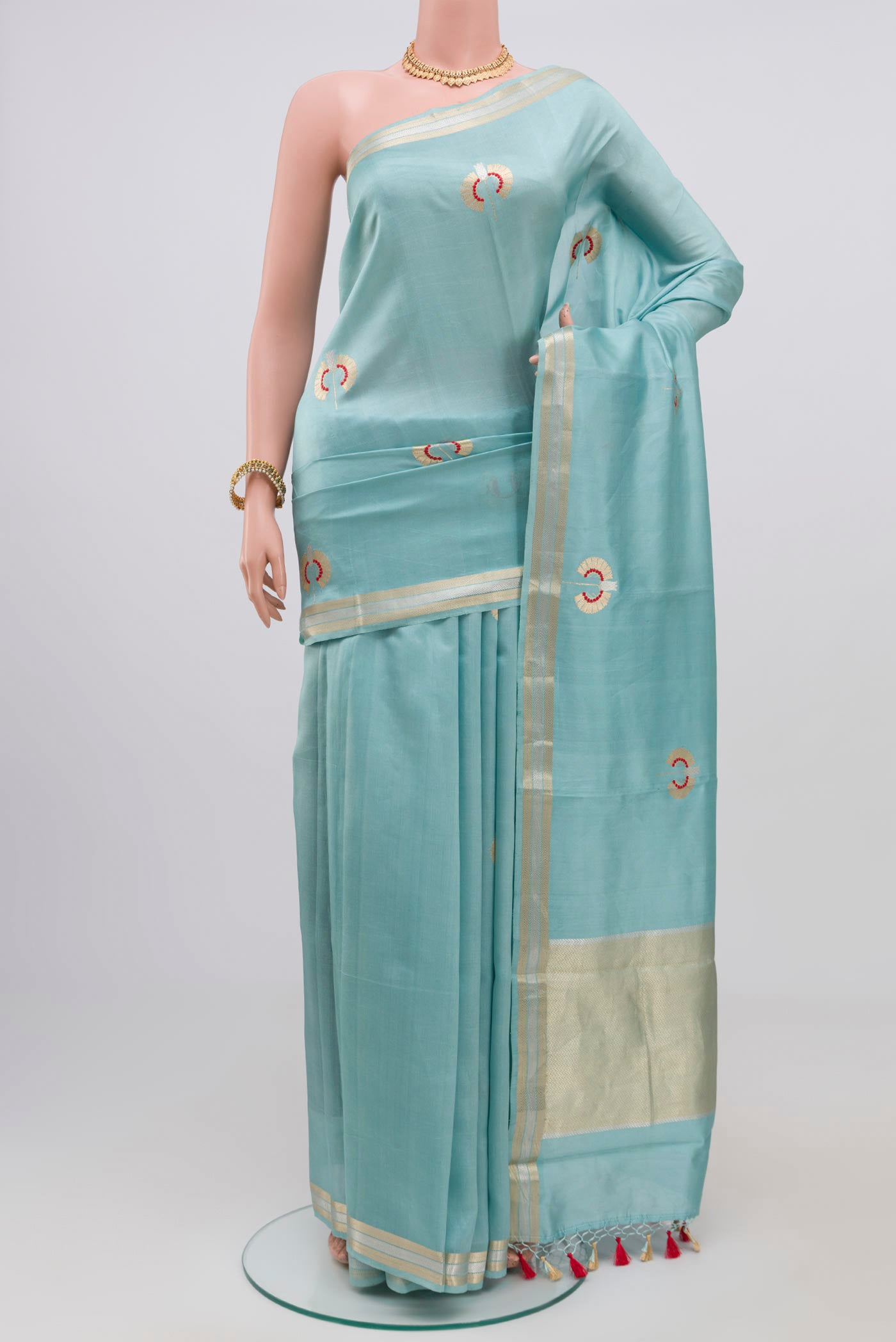 Sky Blue Banarasi Katan Silk Saree with Zari Butta on the body and Zari Border.  displayed on a mannequin