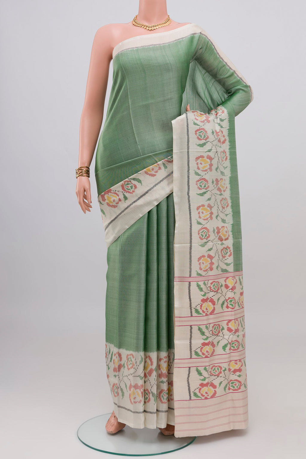 Light Green Rajkot Patola Silk Saree with Plain Body and Plain Border.  displayed on a mannequin