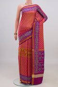 Pinkish Yellow Rajkot Patola Silk Saree with Ikat design on the body and Ikat Border.  displayed on a mannequin