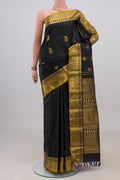Pure Silk Black Kanjivaram Saree with Zari Butta on the body and Zari Border.  displayed on a mannequin