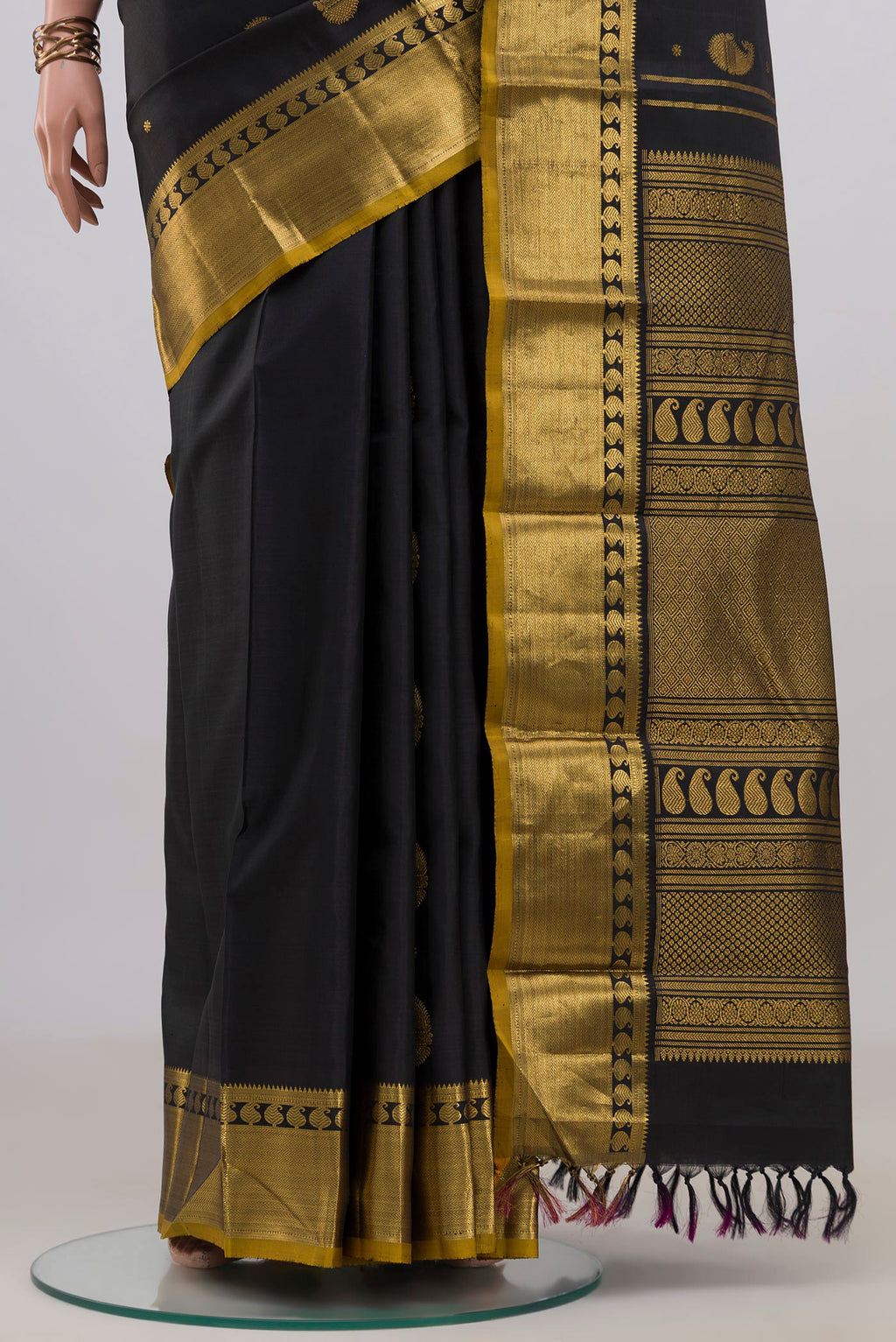 Pleats and pallu of Pure Silk Black Kanjivaram Saree with Zari Butta on the body and Zari Border. 