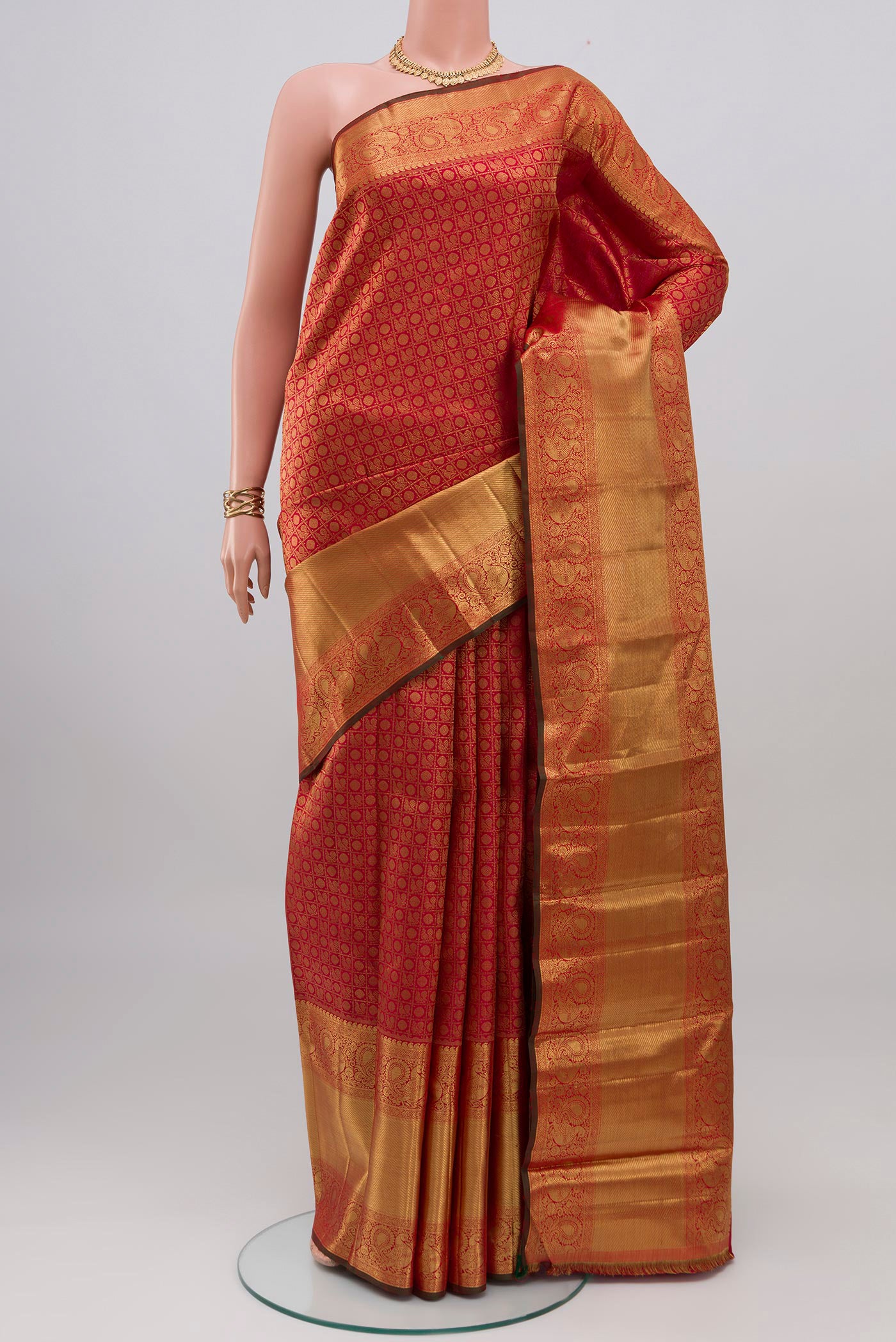 Pure Silk Pure Zari Red Kanjivaram Saree with Zari Brocade on the body and Zari Border.  displayed on a mannequin