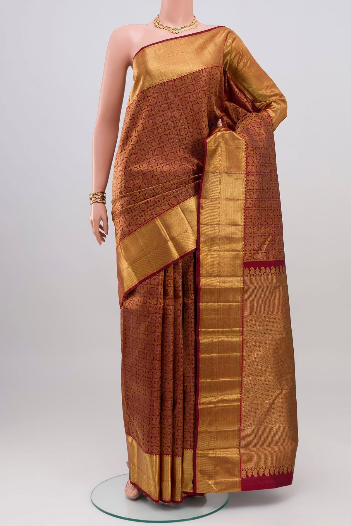 Pure Silk Pure Zari Maroon Kanjivaram Saree with Zari Brocade on the body and Zari Border.  displayed on a mannequin