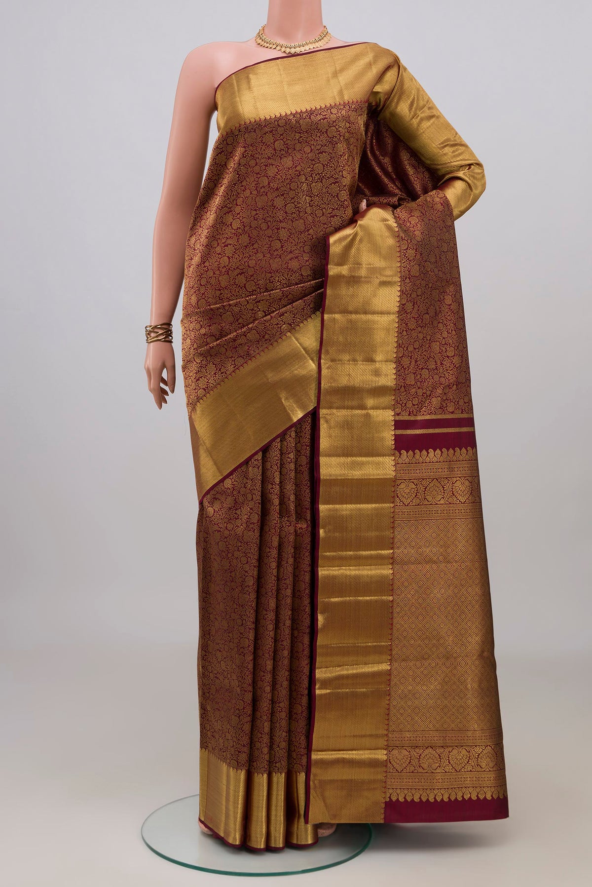 Pure Silk Pure Zari Coffee Brown Kanjivaram Saree with Zari Brocade on the body and Zari Border.  displayed on a mannequin