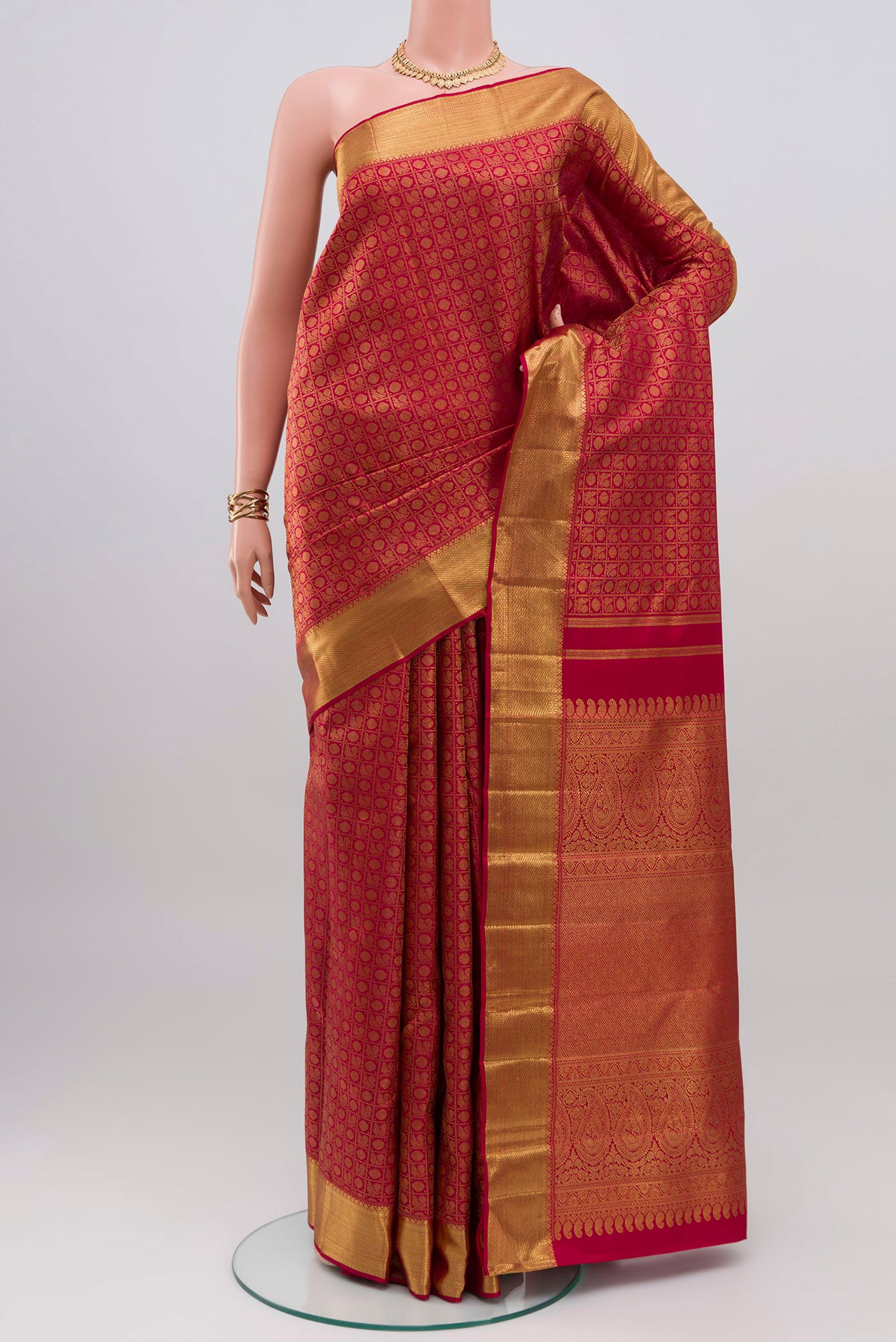 Maroon Kanchipuram Silk Saree with Zari Brocade on the body and Zari Border.  displayed on a mannequin