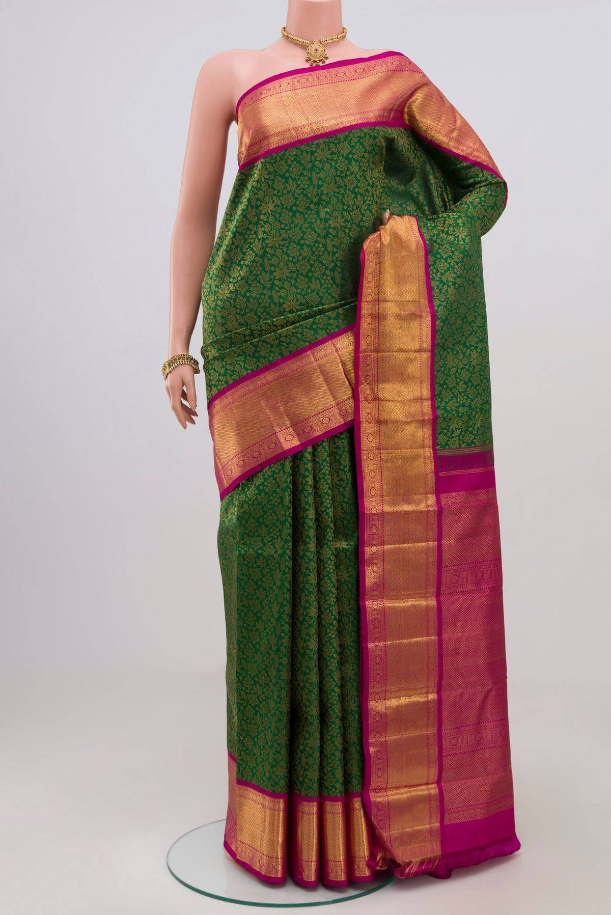 Pure Silk Pure Zari Green Kanjivaram Saree with Zari Brocade on the body and Zari Border.  displayed on a mannequin