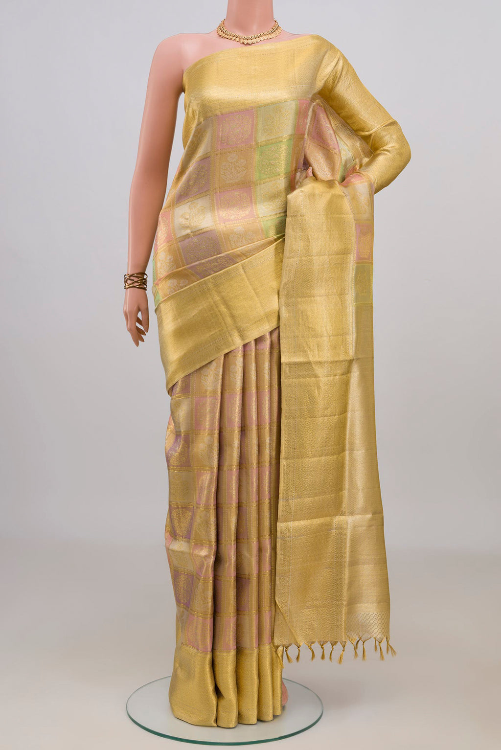Pure Silk Gold Dual Tone Kanjivaram Tissue Saree with Zari Brocade on the body and Zari Border.  displayed on a mannequin