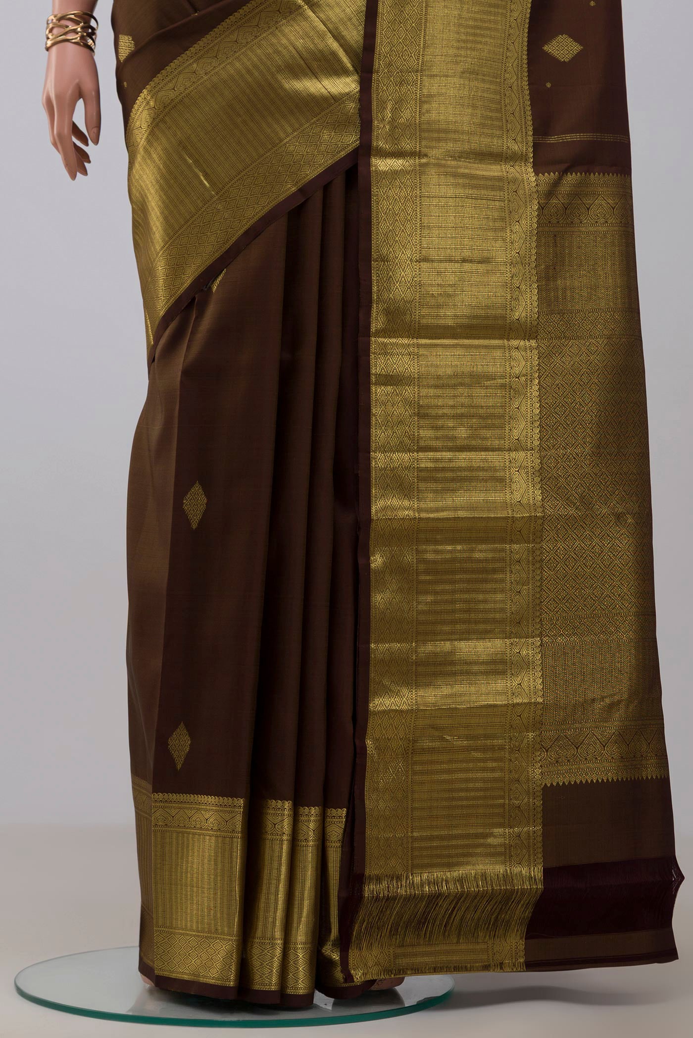 Pleats and pallu of Mehandi Green Kanjivaram Silk Saree with Zari Butta on the body and Zari Border. 
