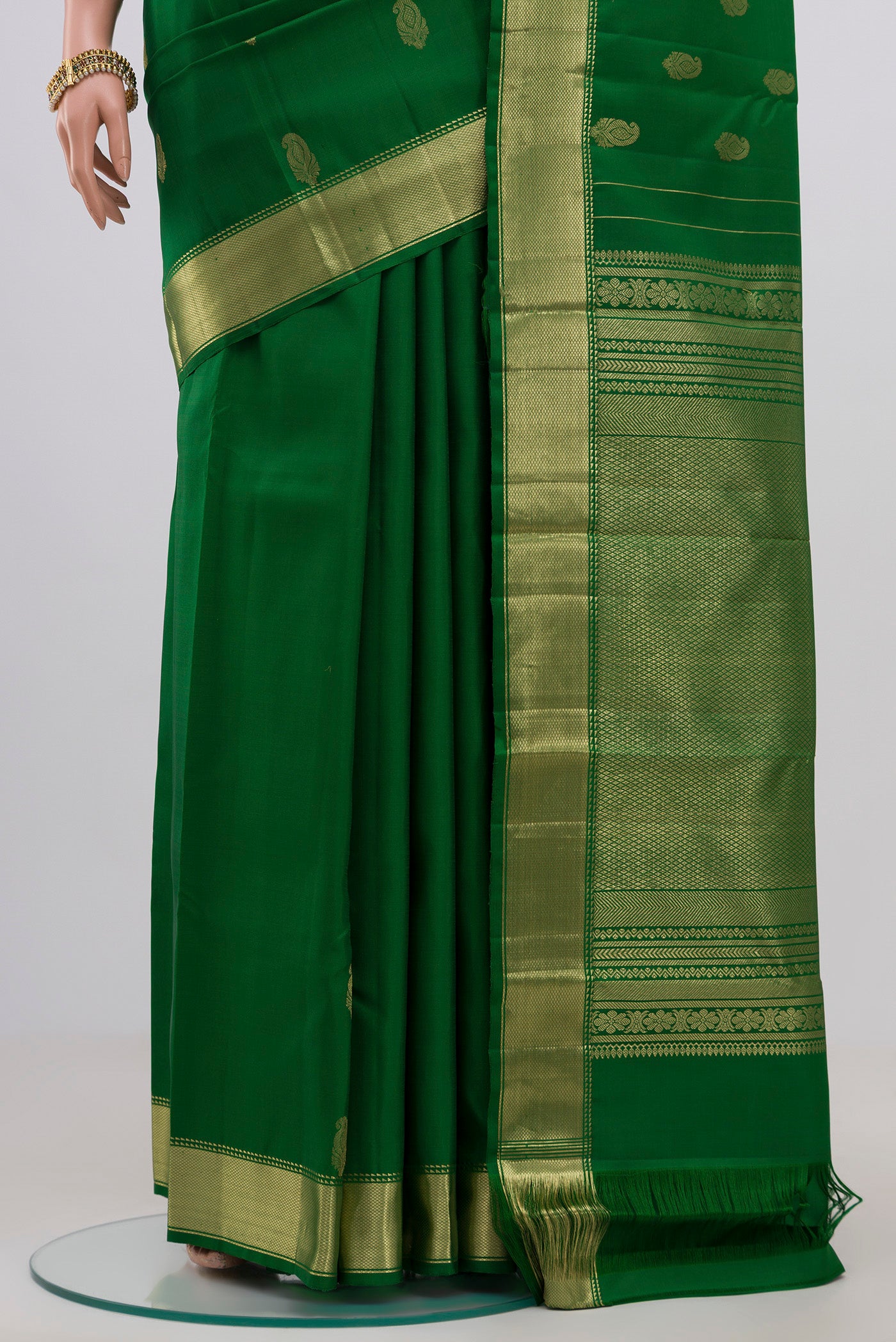 Pleats and pallu of Green Kanchipuram Silk Saree with Zari Butta on the body and Zari Border. 