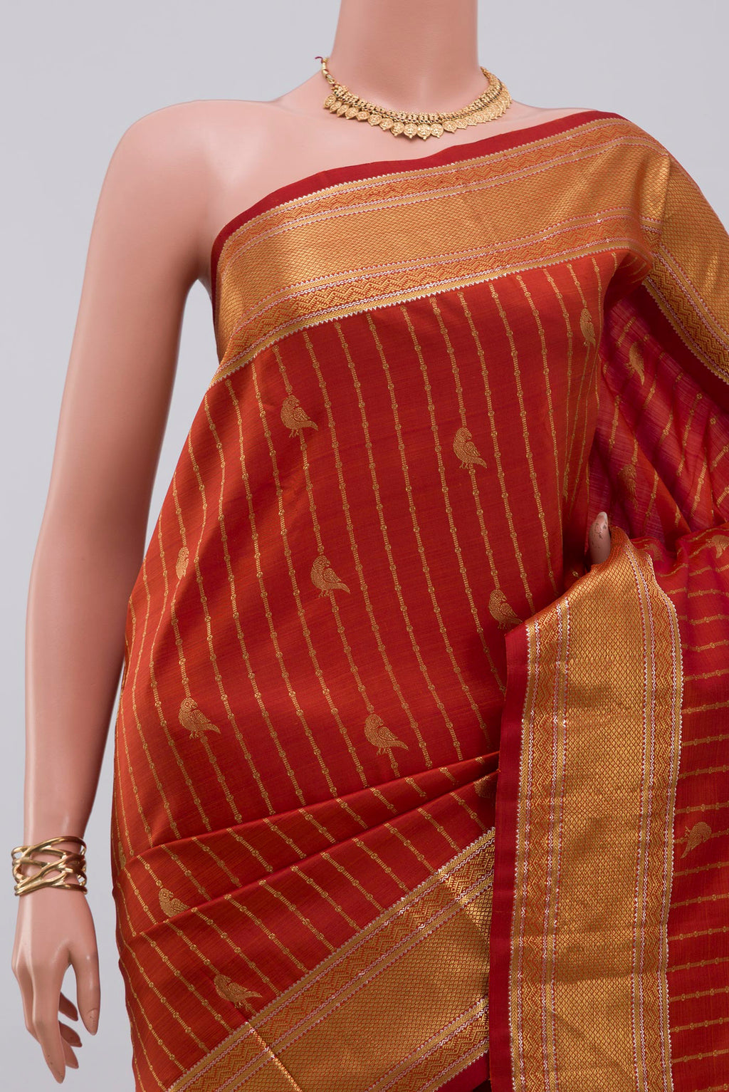 Border image of Rust Kanchipuram Silk Saree with Stripes on the body and Zari Border. 