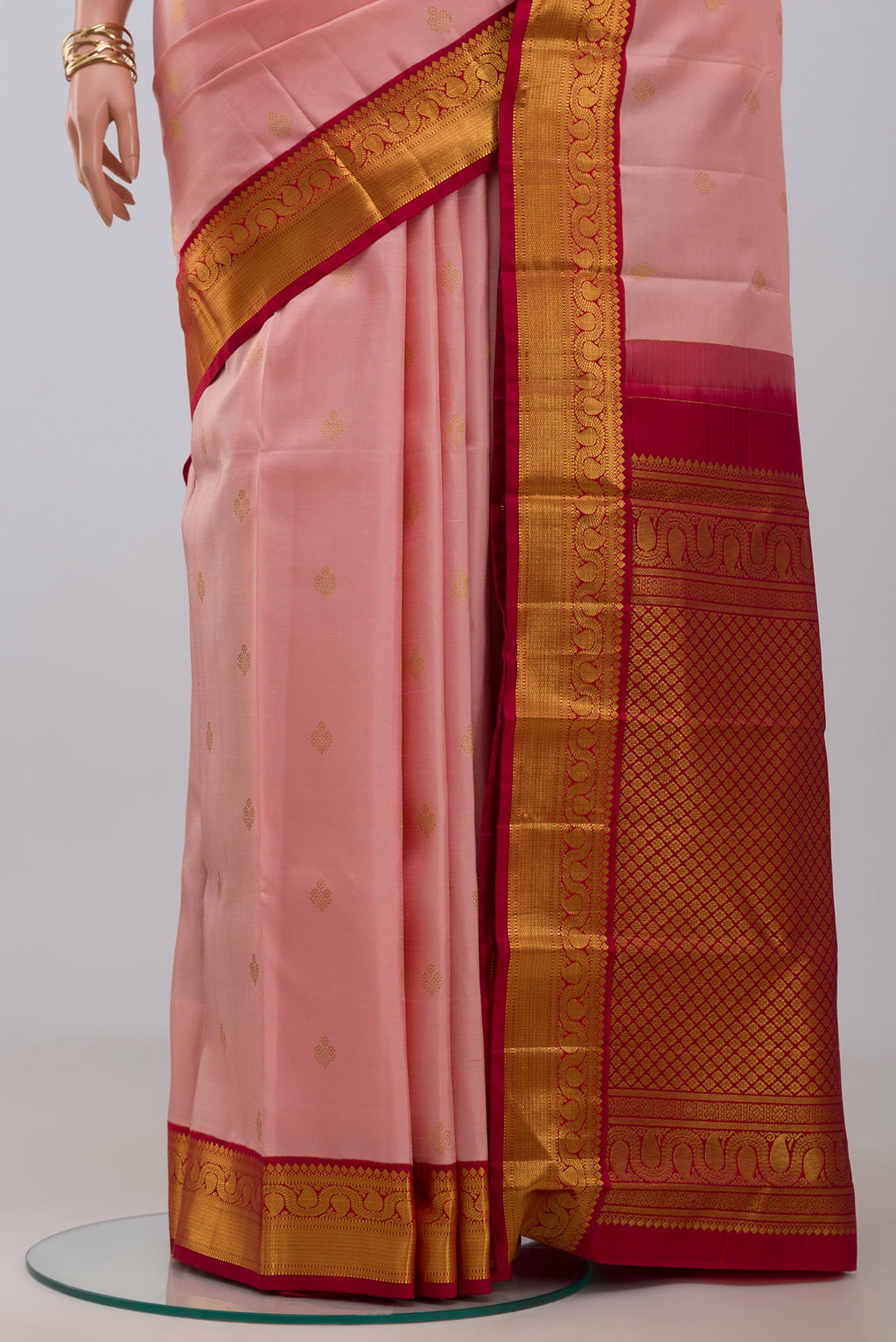 Pleats and pallu of Peach Kanjivaram Silk Saree with Zari Butta on the body and Zari Border. 