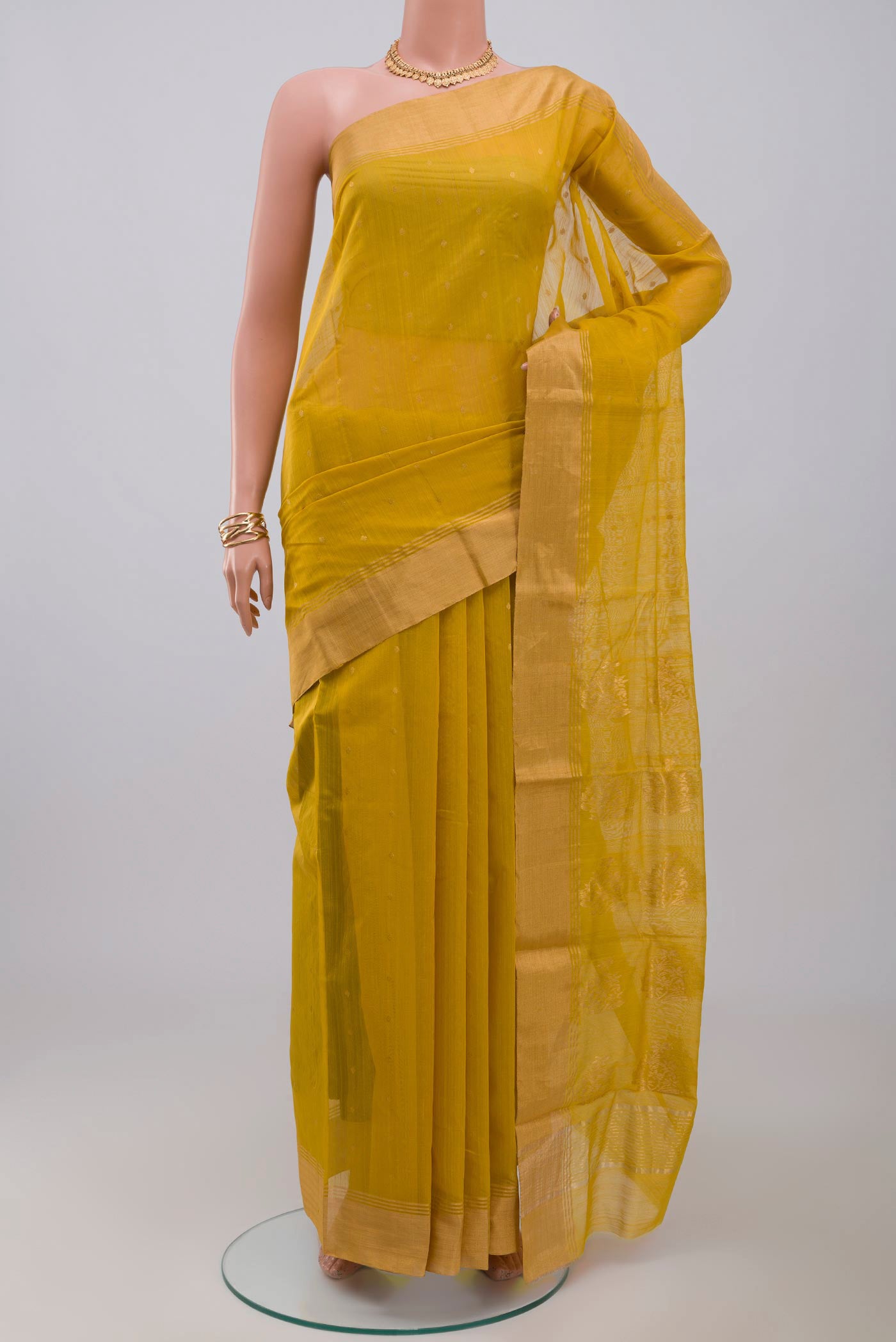 Yellow Chanderi Silk Cotton Saree with Zari Butta on the body and Zari Border.  displayed on a mannequin