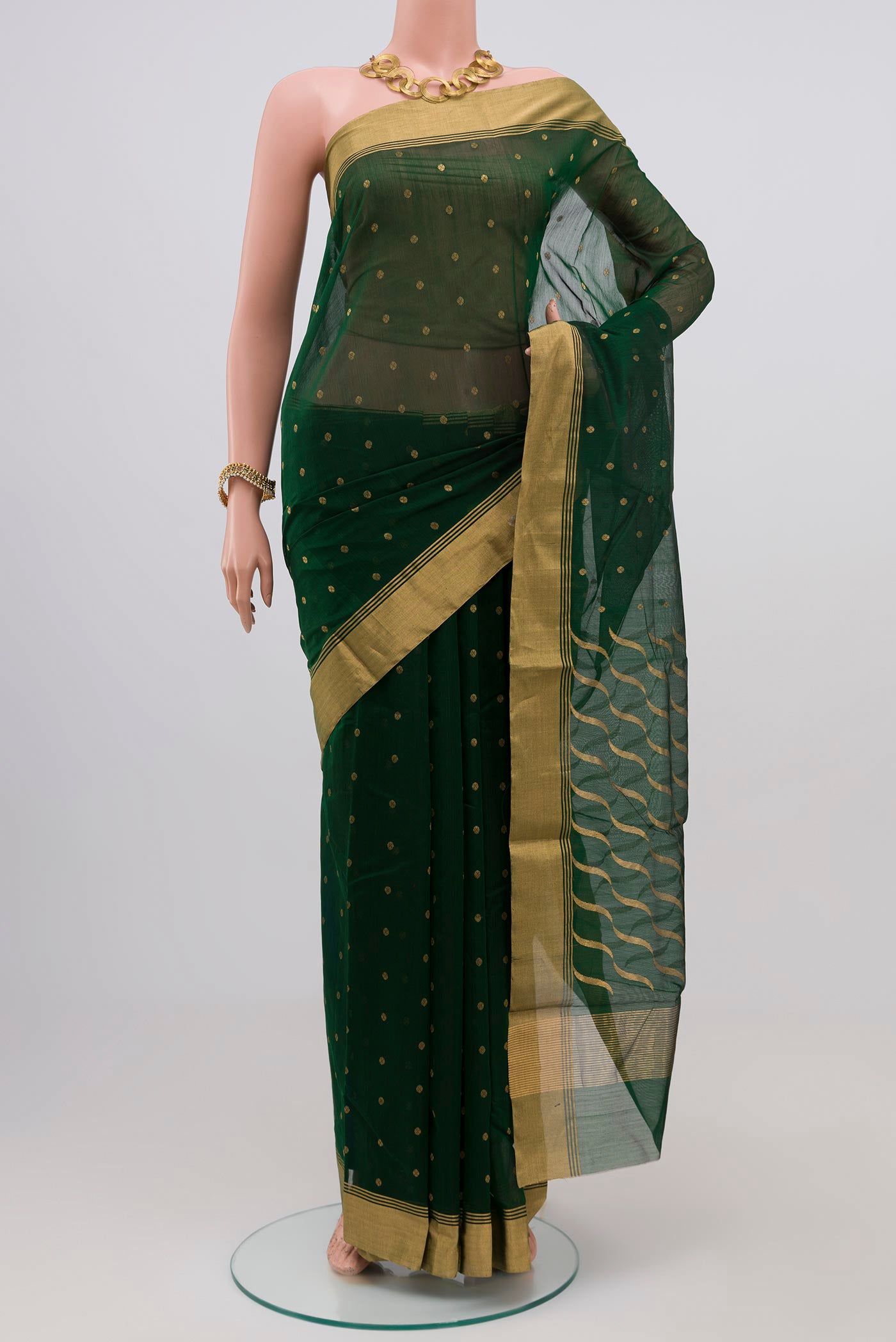 Bottle Green Chanderi Silk Saree with Zari Butta on the body and Zari Border.  displayed on a mannequin