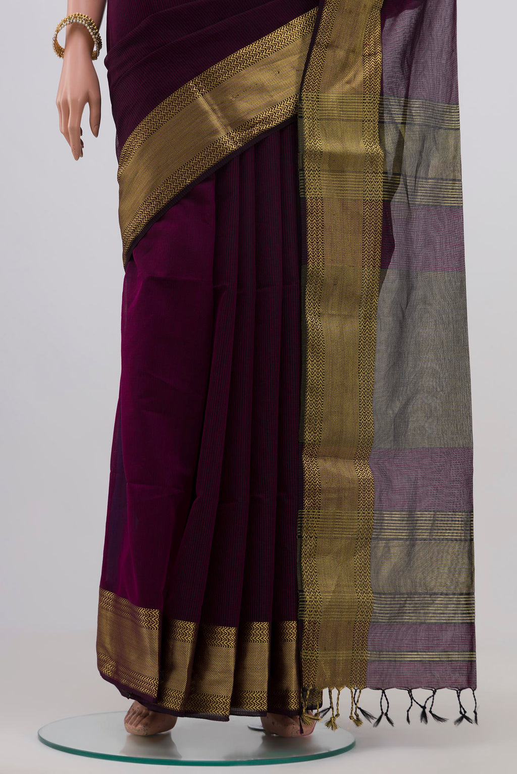 Pleats and pallu of Purple Maheshwari Silk Saree with Stripes on the body and Zari Border. 