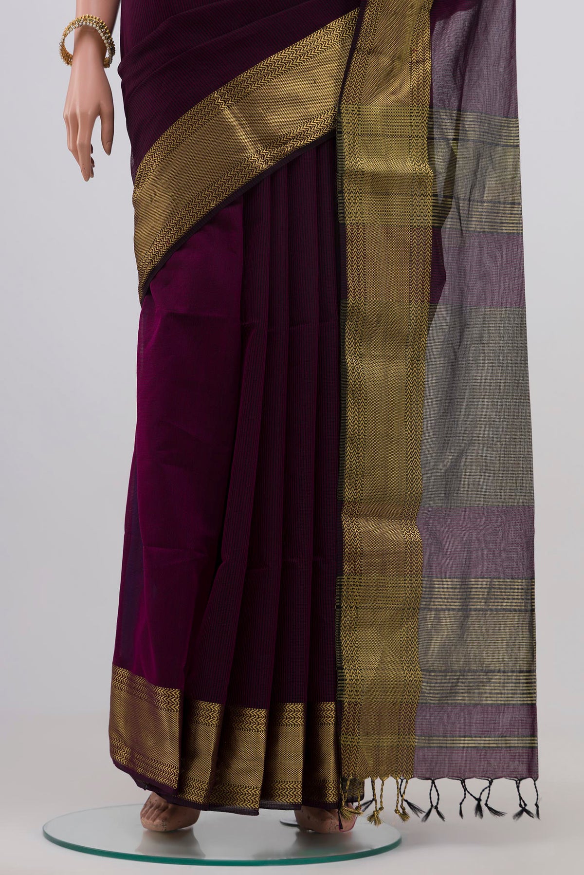 Pleats and pallu of Purple Maheshwari Silk Saree with Stripes on the body and Zari Border. 