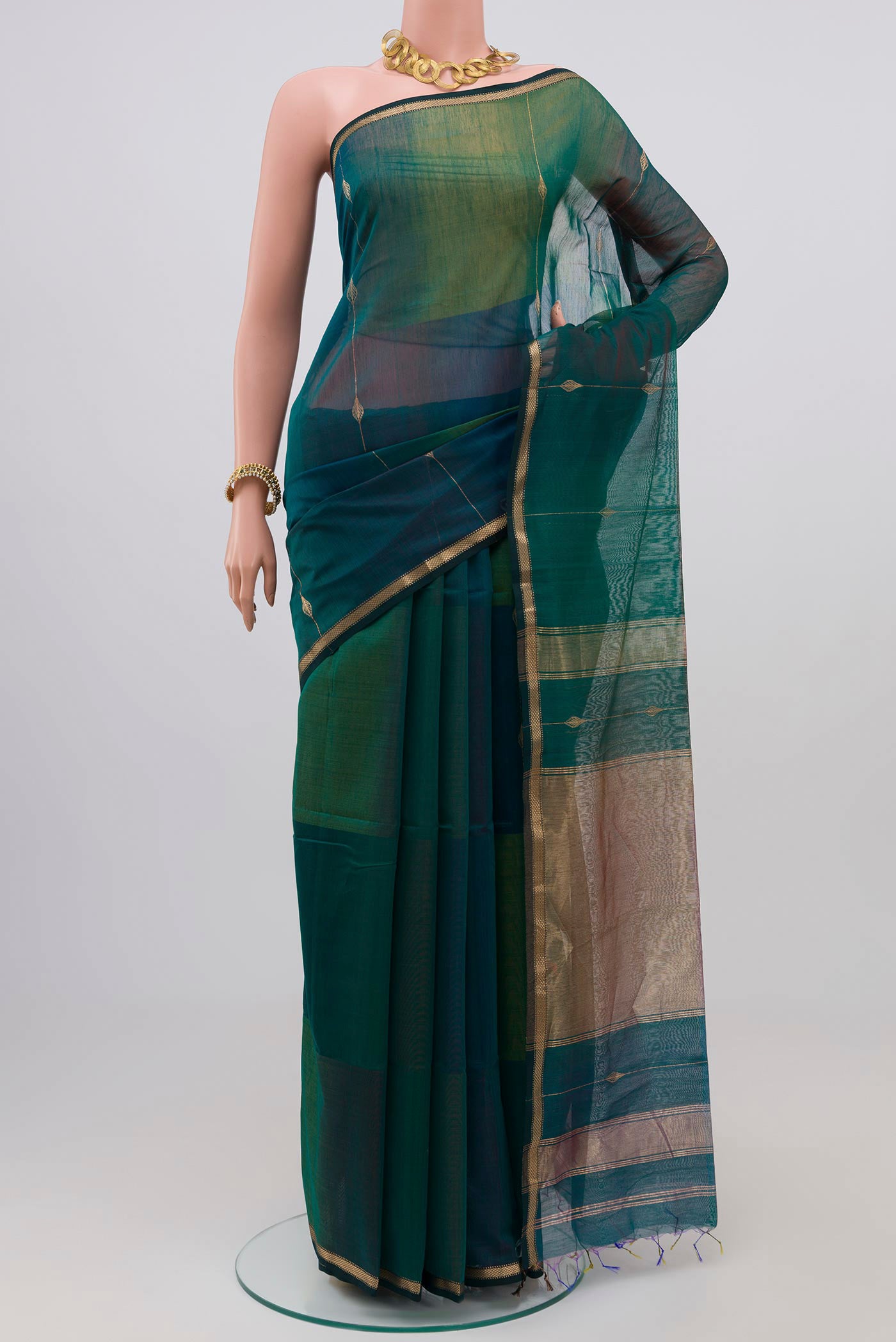 Green Maheshwari Silk Saree with Zari Butta on the body and Zari Border.  displayed on a mannequin