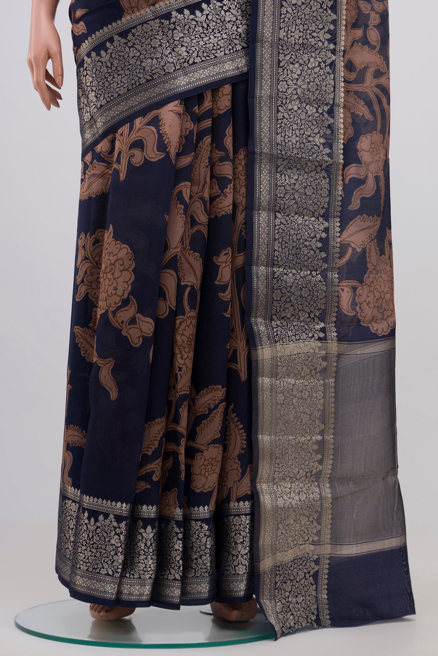 Pleats and pallu of Blue Raw Silk Saree with Printed design on the body and Plain Border. 