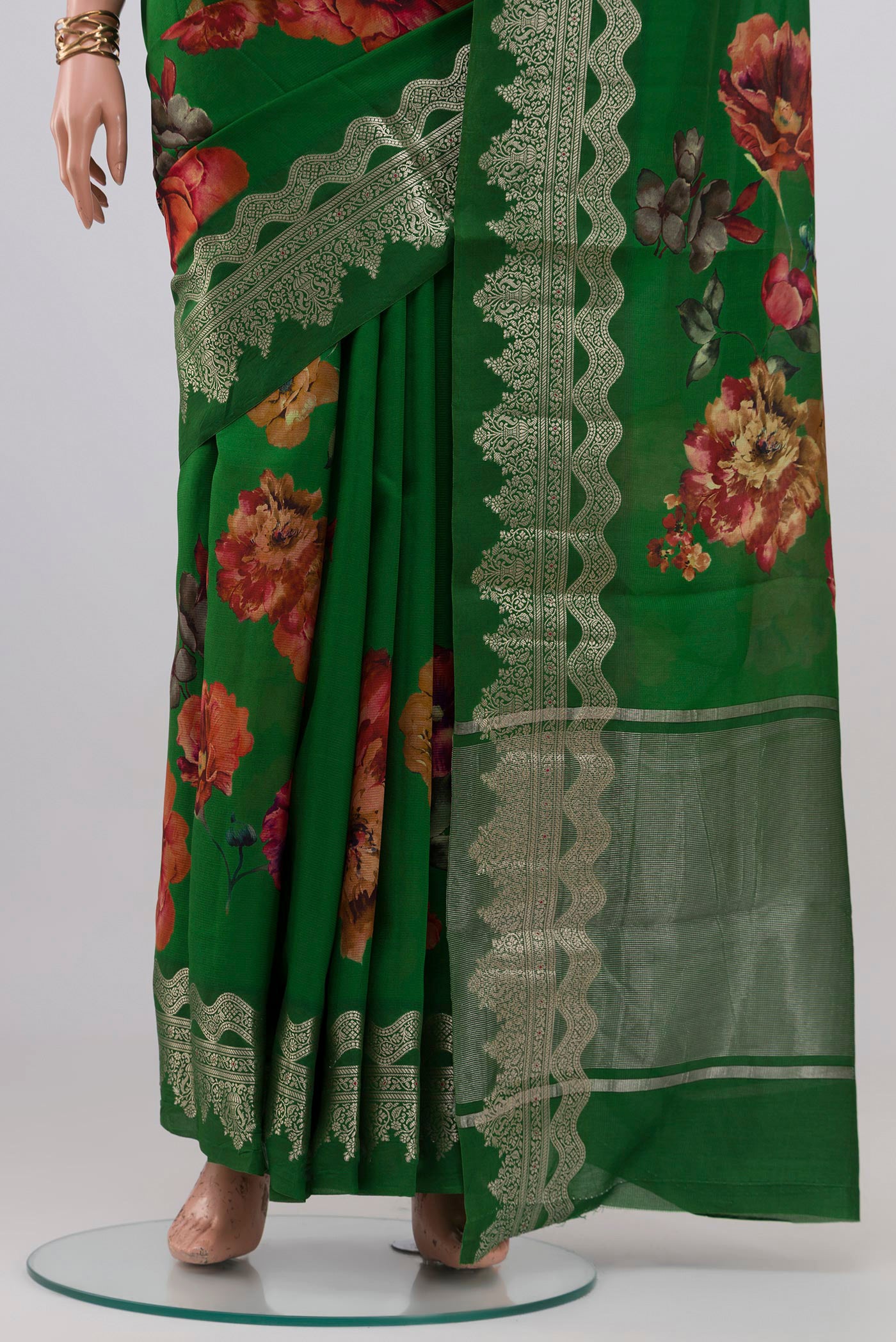Pleats and pallu of Green Raw Silk Saree with Floral Print on the body and Fancy Border. 
