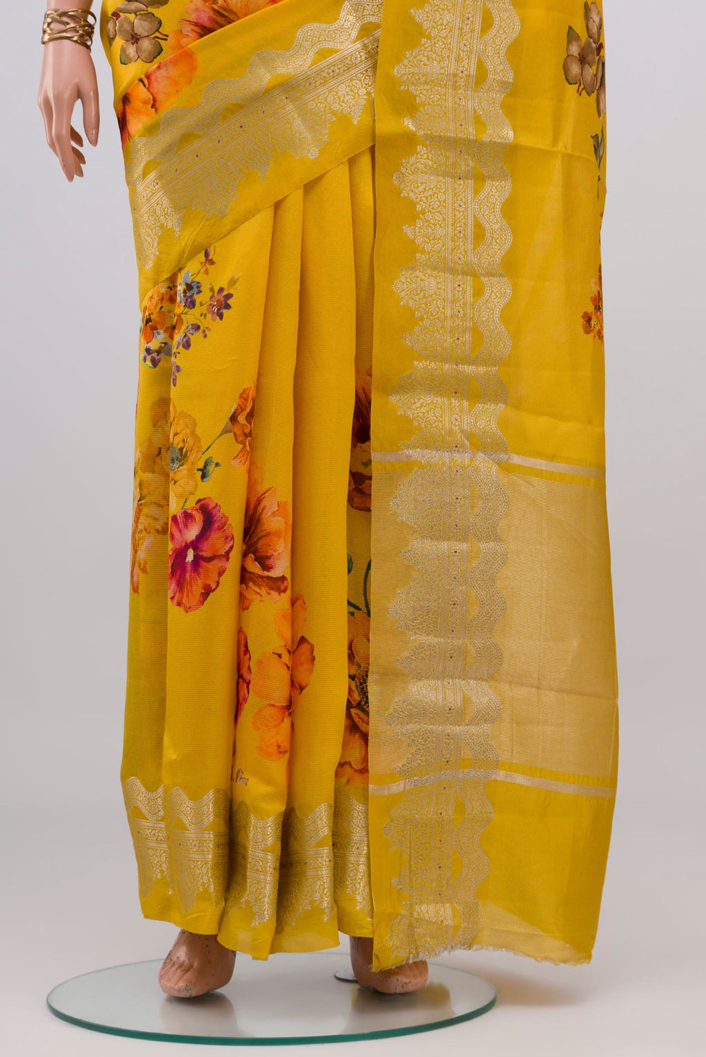 Pleats and pallu of Yellow Raw Silk Saree with Floral Print on the body and Fancy Border. 