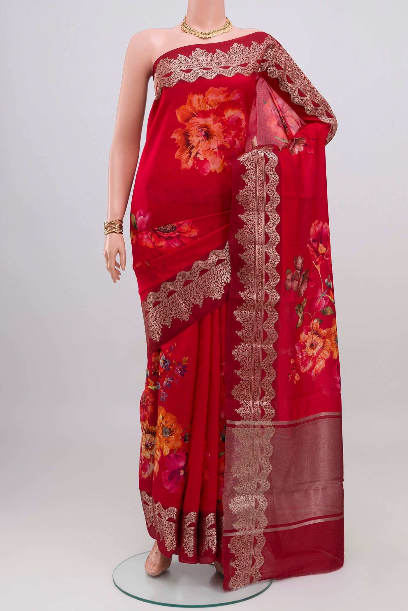 Red Raw Silk Saree with Floral Print on the body and Fancy Border.  displayed on a mannequin
