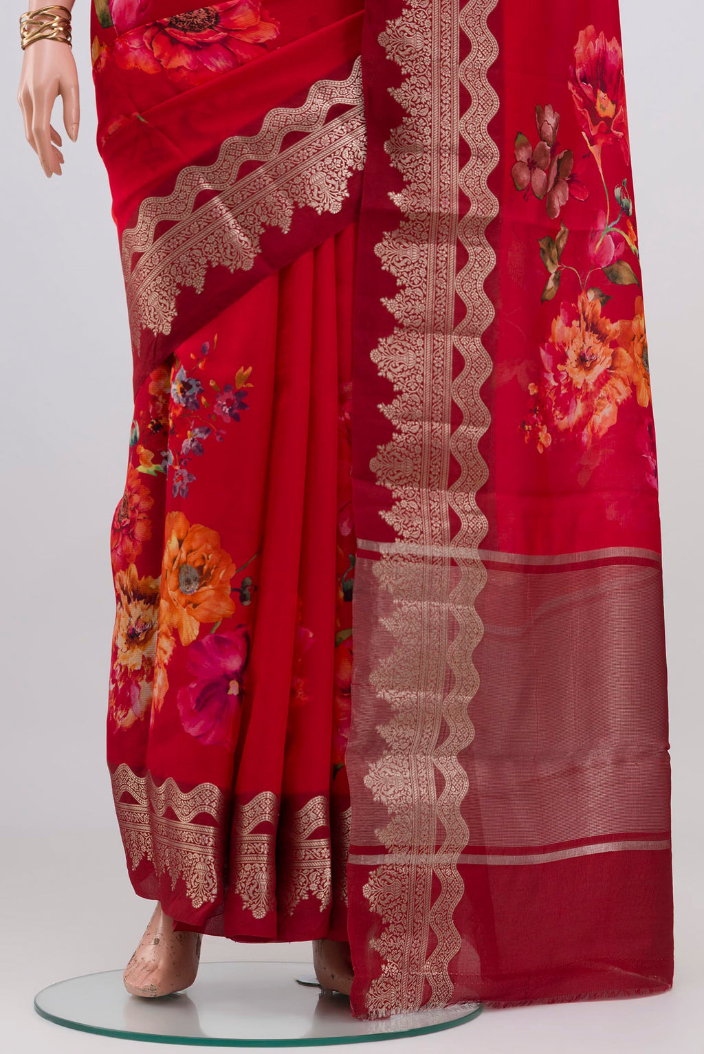 Pleats and pallu of Red Raw Silk Saree with Floral Print on the body and Fancy Border. 
