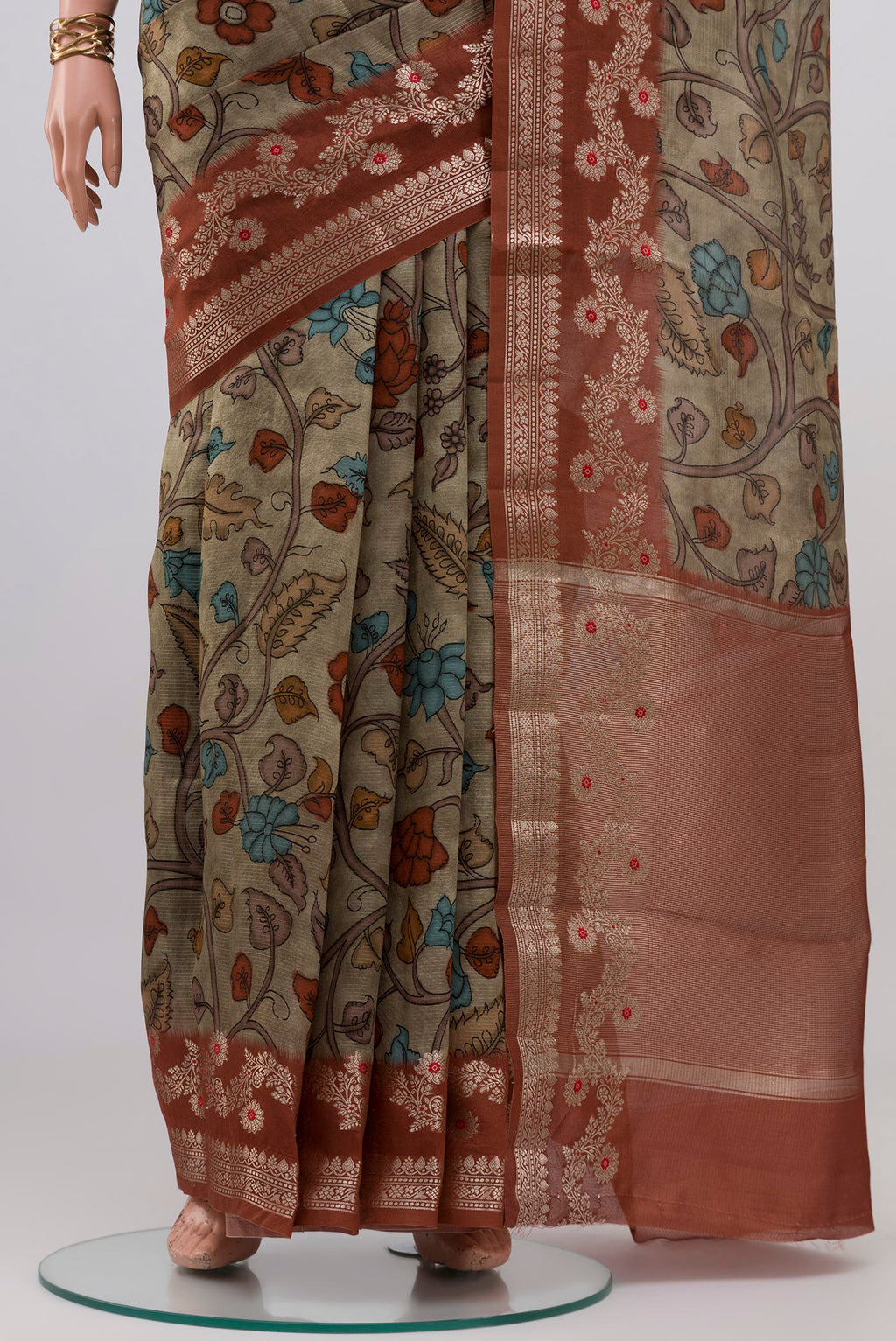 Pleats and pallu of Beige Raw Silk Saree with Printed design on the body and Fancy Border. 