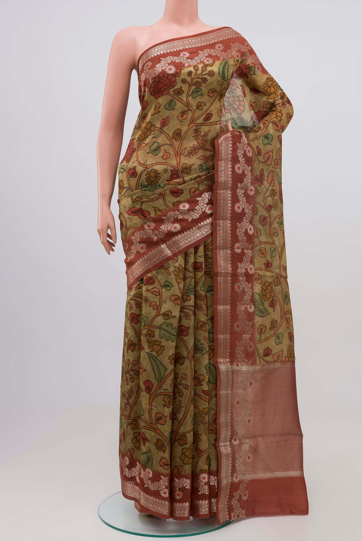 Mehandi Green Raw Silk Saree with kalamkari Print on the body and Plain Border.  displayed on a mannequin