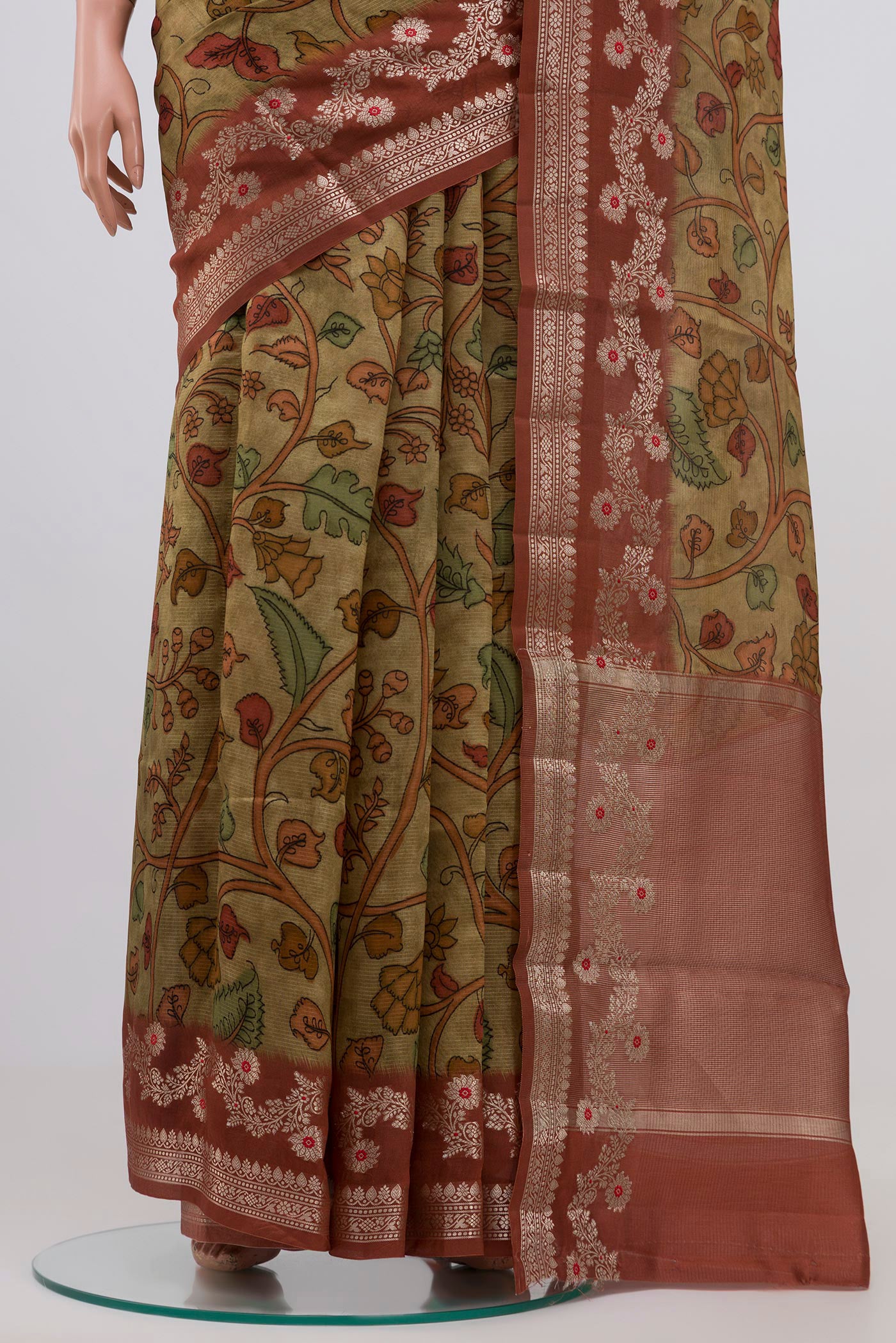 Pleats and pallu of Mehandi Green Raw Silk Saree with kalamkari Print on the body and Plain Border. 