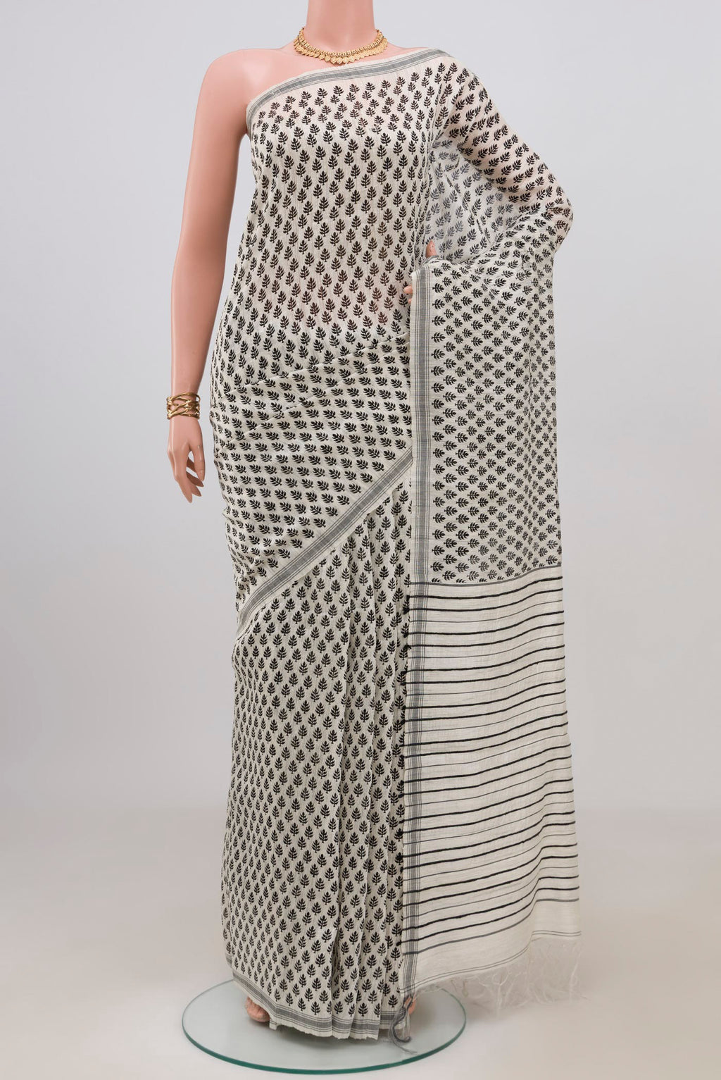 White Tussar Silk Saree with Printed design on the body and Plain Border.  displayed on a mannequin