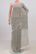 White Tussar Silk Saree with Printed design on the body and Plain Border.  displayed on a mannequin