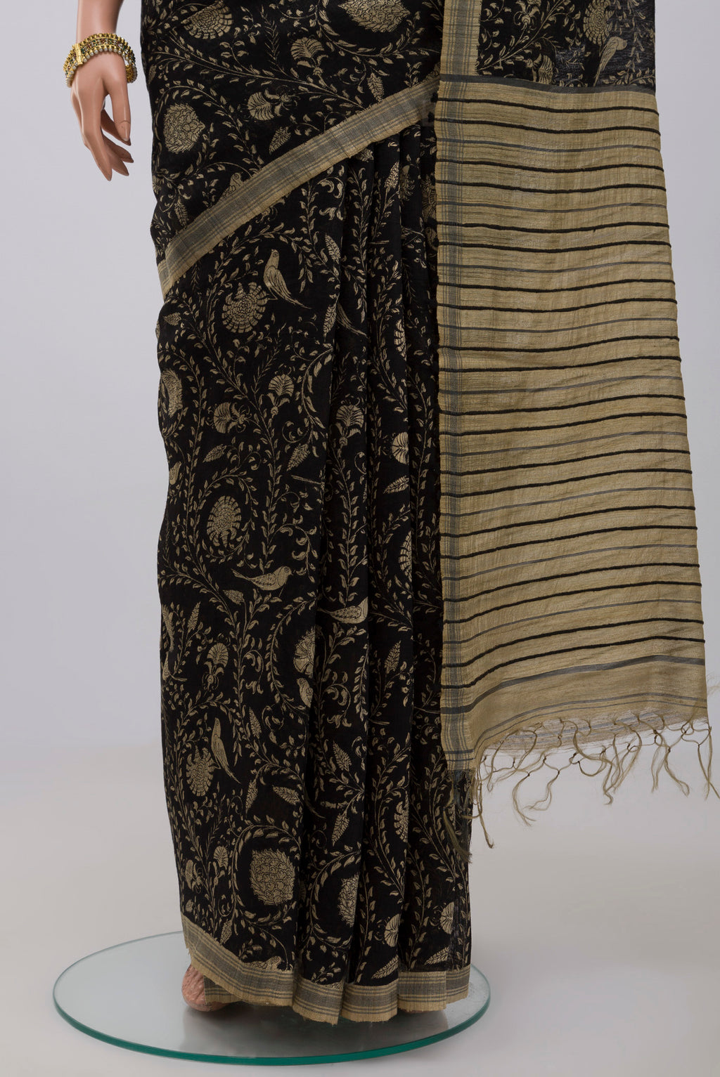 Pleats and pallu of Black Jute Silk Saree with Fancy on the body and Without Border. 