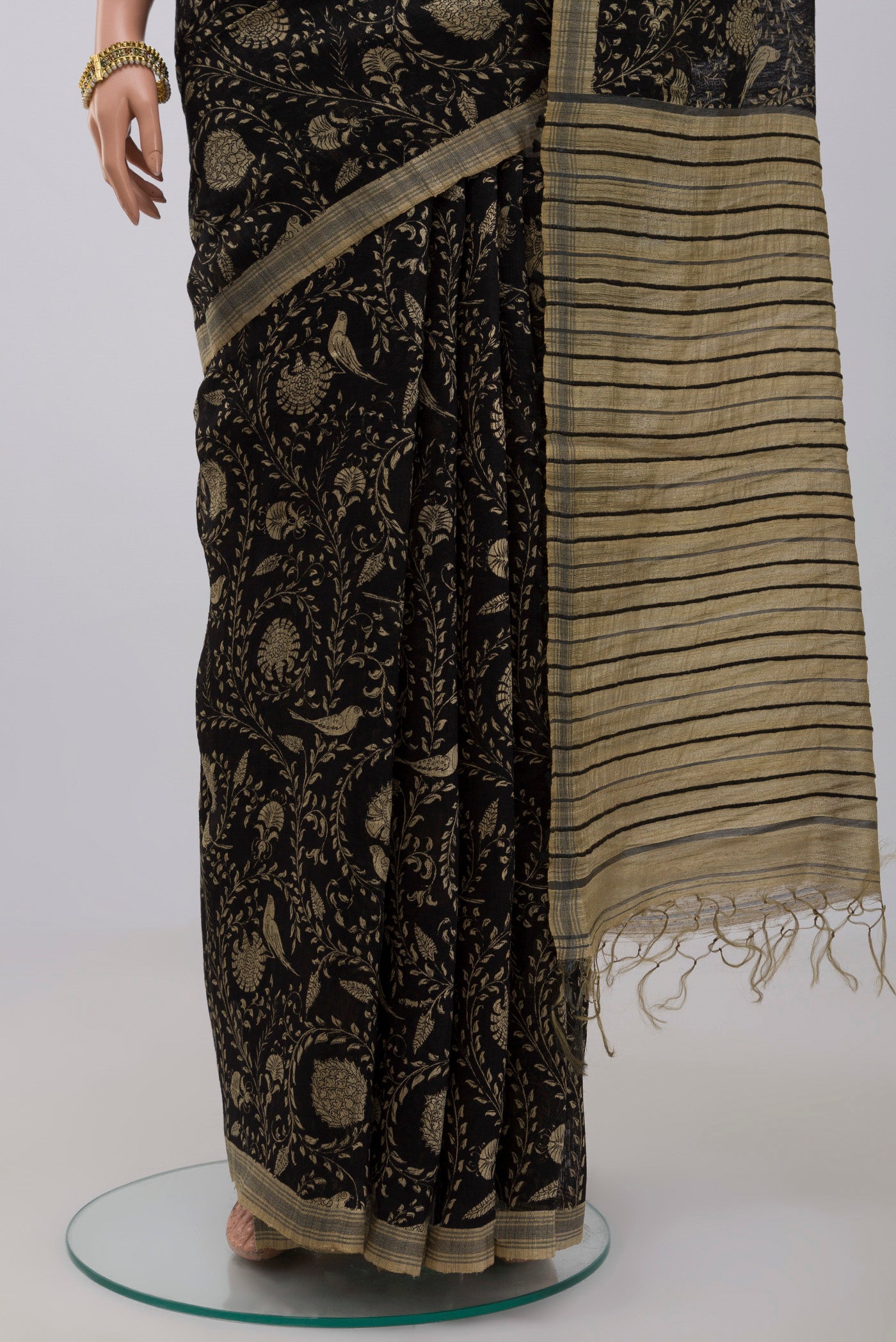 Pleats and pallu of Black Jute Silk Saree with Fancy on the body and Without Border. 