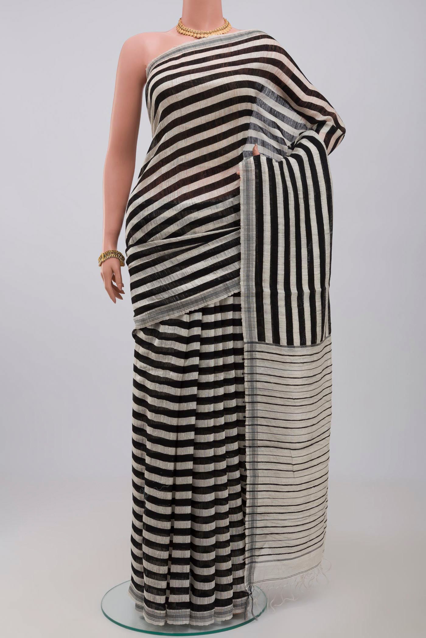 Black Jute Silk Saree with Fancy on the body and Without Border.  displayed on a mannequin