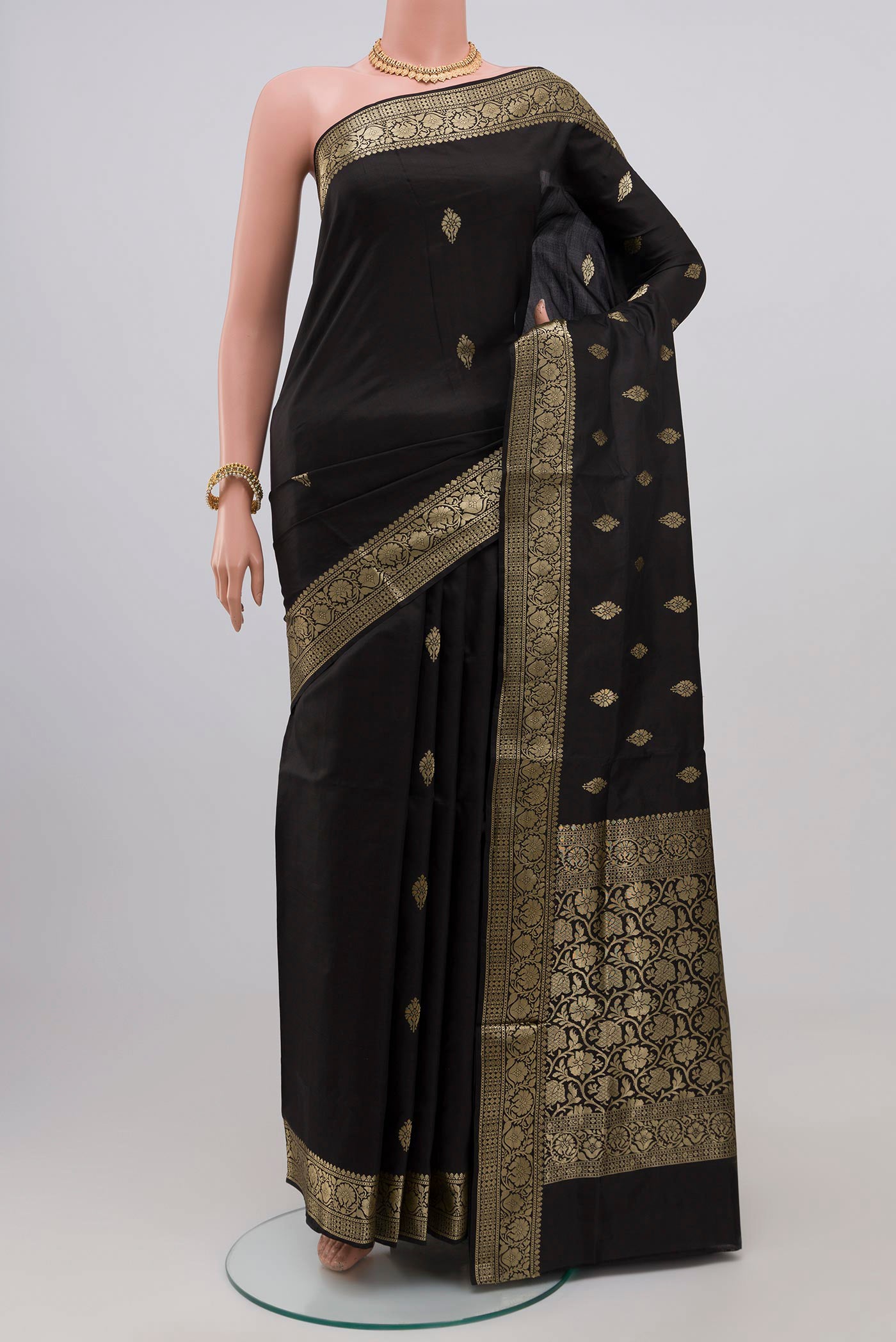 Black Banarasi Katan Silk Saree with Zari Butta on the body and Zari Border.  displayed on a mannequin
