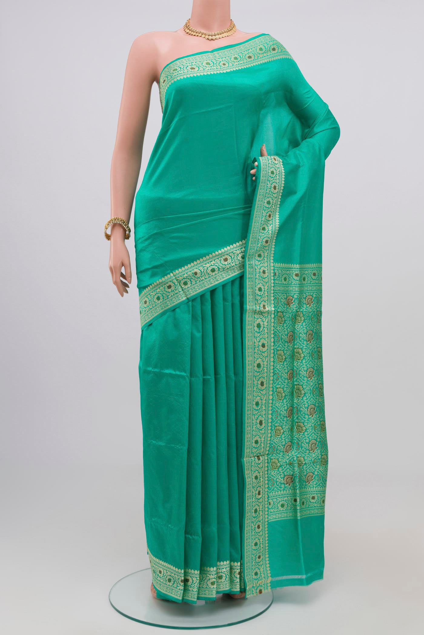 Light Green Banarasi Katan Silk Saree with Plain Body and Thread Border.  displayed on a mannequin