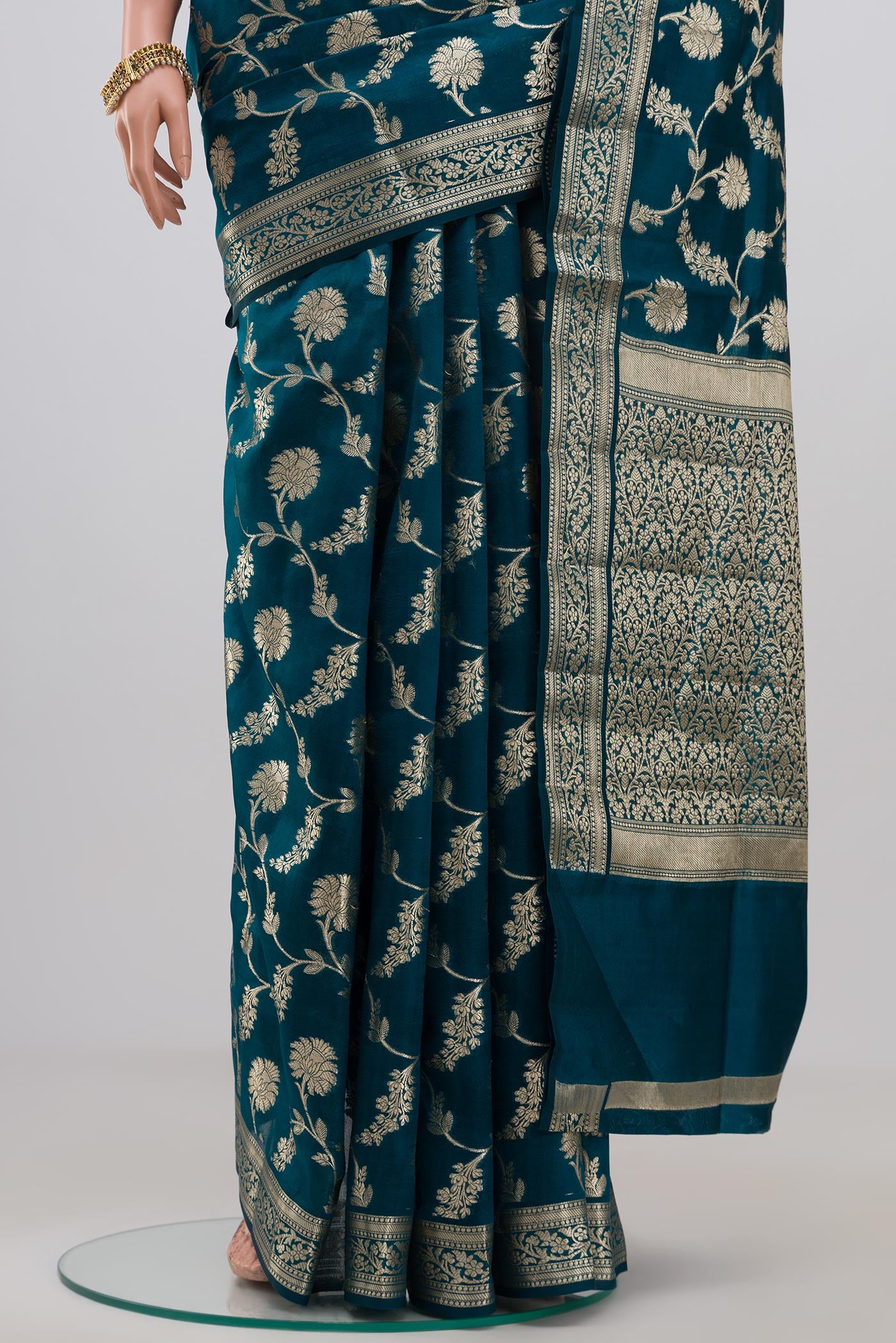 Pleats and pallu of Blue Raw Silk Saree with Fancy on the body and Zari Border. 