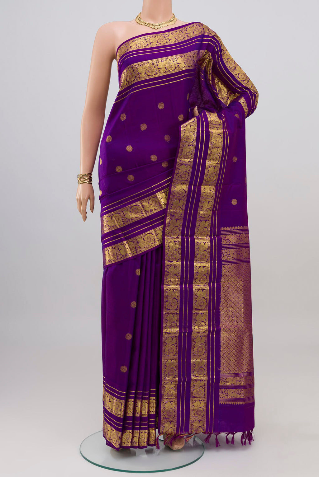 Violet Kanjivaram Silk Saree with Zari Butta on the body and Zari Border.  displayed on a mannequin