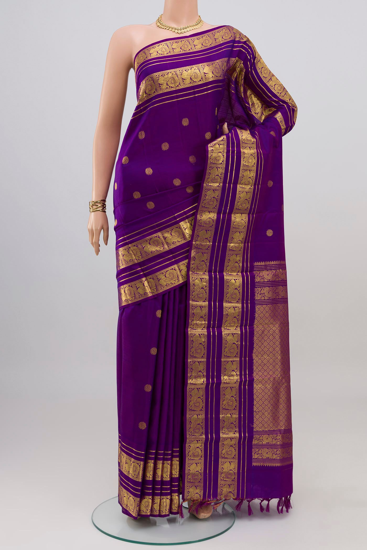 Violet Kanjivaram Silk Saree with Zari Butta on the body and Zari Border.  displayed on a mannequin