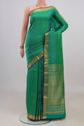 Pure Silk Green Kanchipuram Saree with Zari Butta on the body and Zari Border.  displayed on a mannequin
