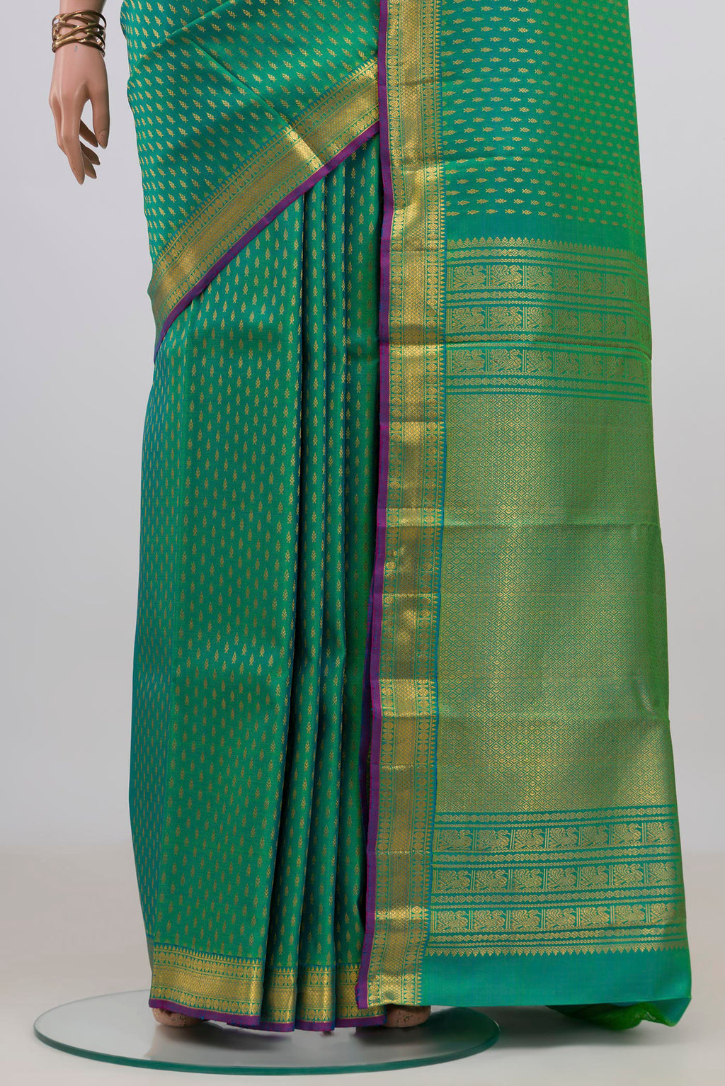 Pleats and pallu of Pure Silk Green Kanchipuram Saree with Zari Butta on the body and Zari Border. 