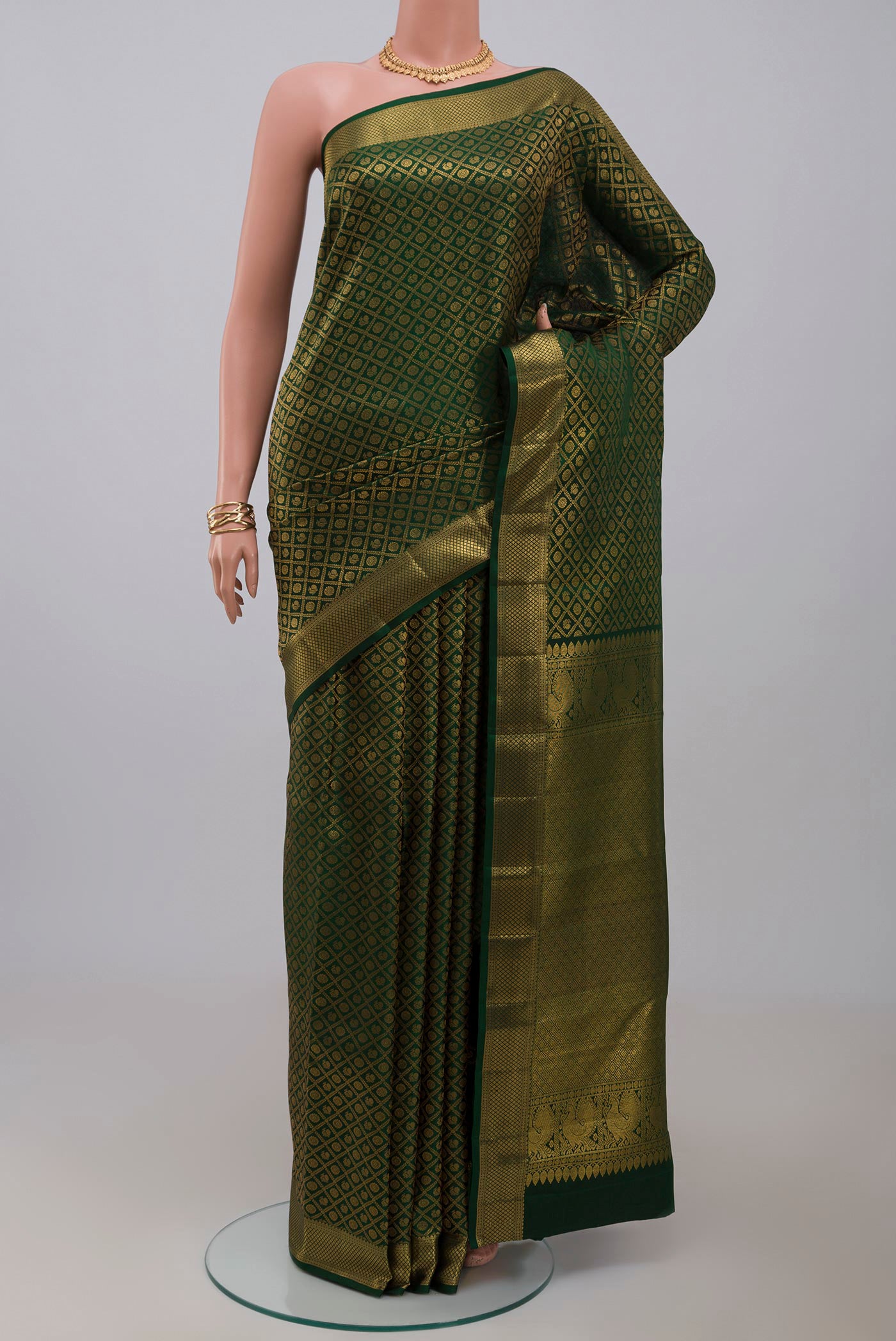 Green Kanchipuram Silk Saree with Zari Brocade on the body and Zari Border.  displayed on a mannequin