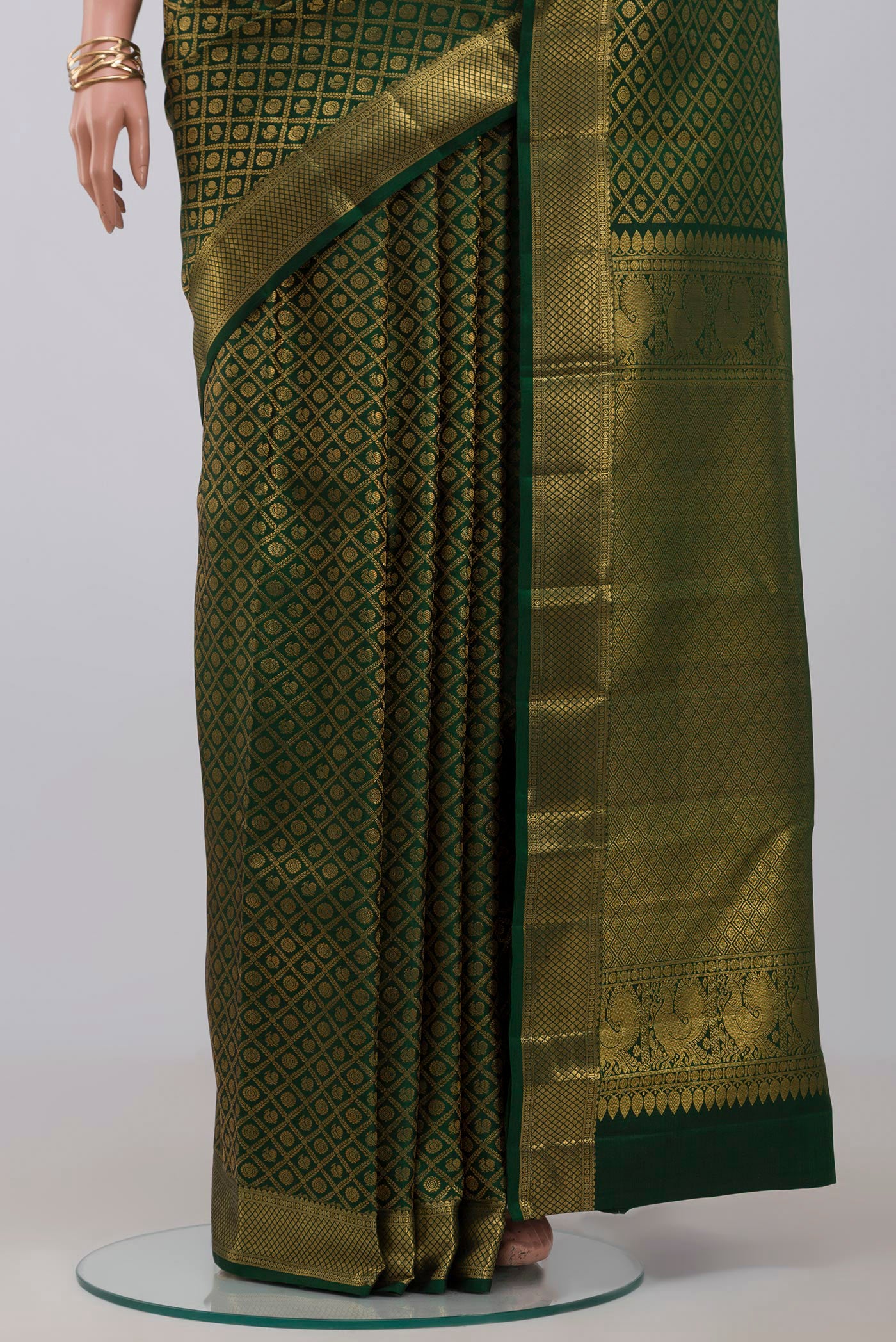 Pleats and pallu of Green Kanchipuram Silk Saree with Zari Brocade on the body and Zari Border. 