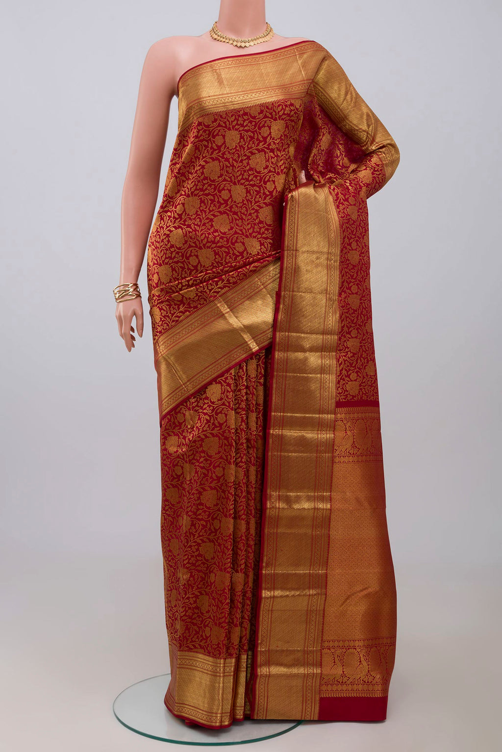 Maroon Kanchipuram Saree with Zari Brocade on the body and Zari Border.  displayed on a mannequin