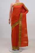 Pure Silk Orange Kanjivaram Saree with Zari Butta on the body and Zari Border.  displayed on a mannequin