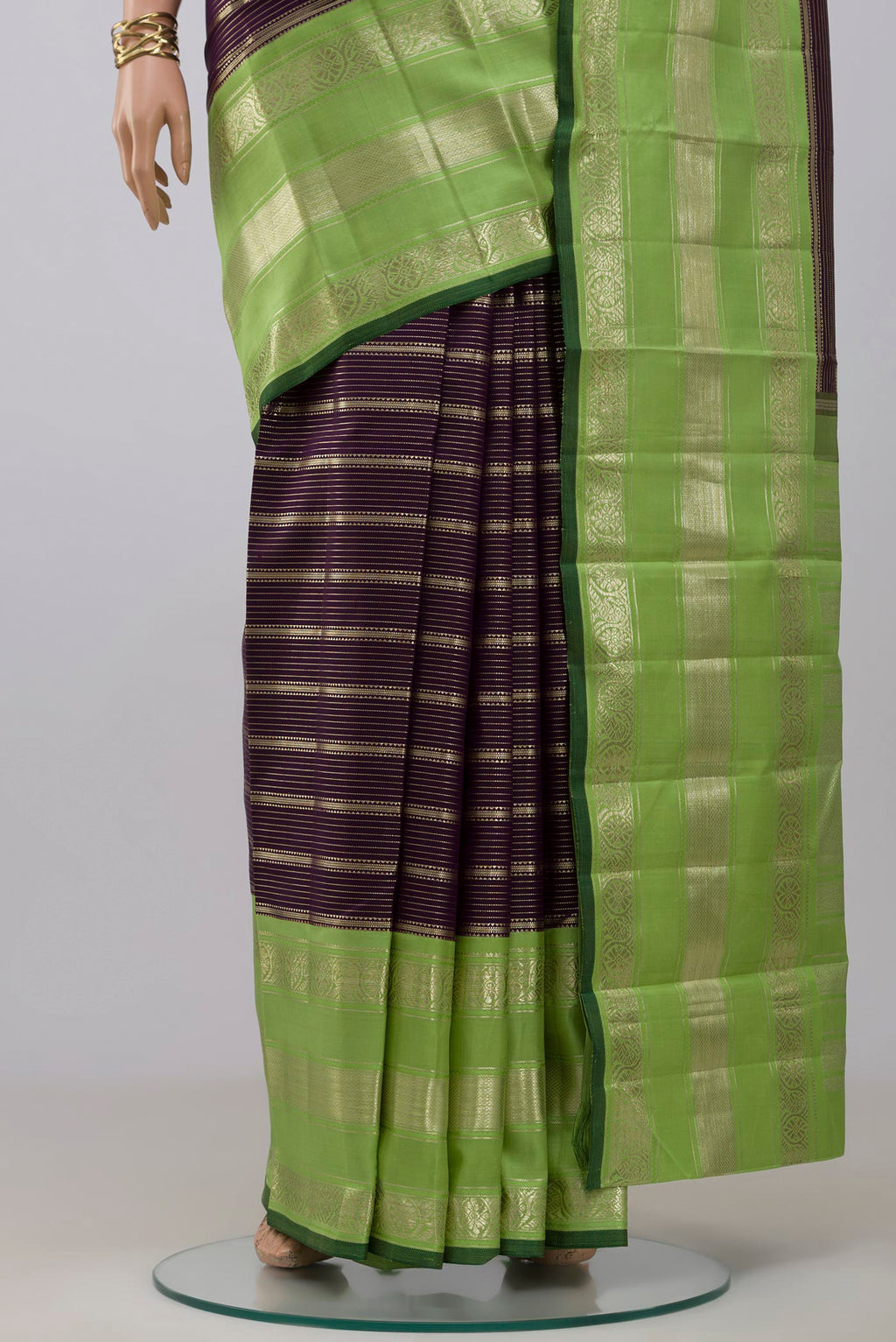 Pleats and pallu of Purple Kanchipuram Silk Saree with Stripes on the body and Zari Border. 