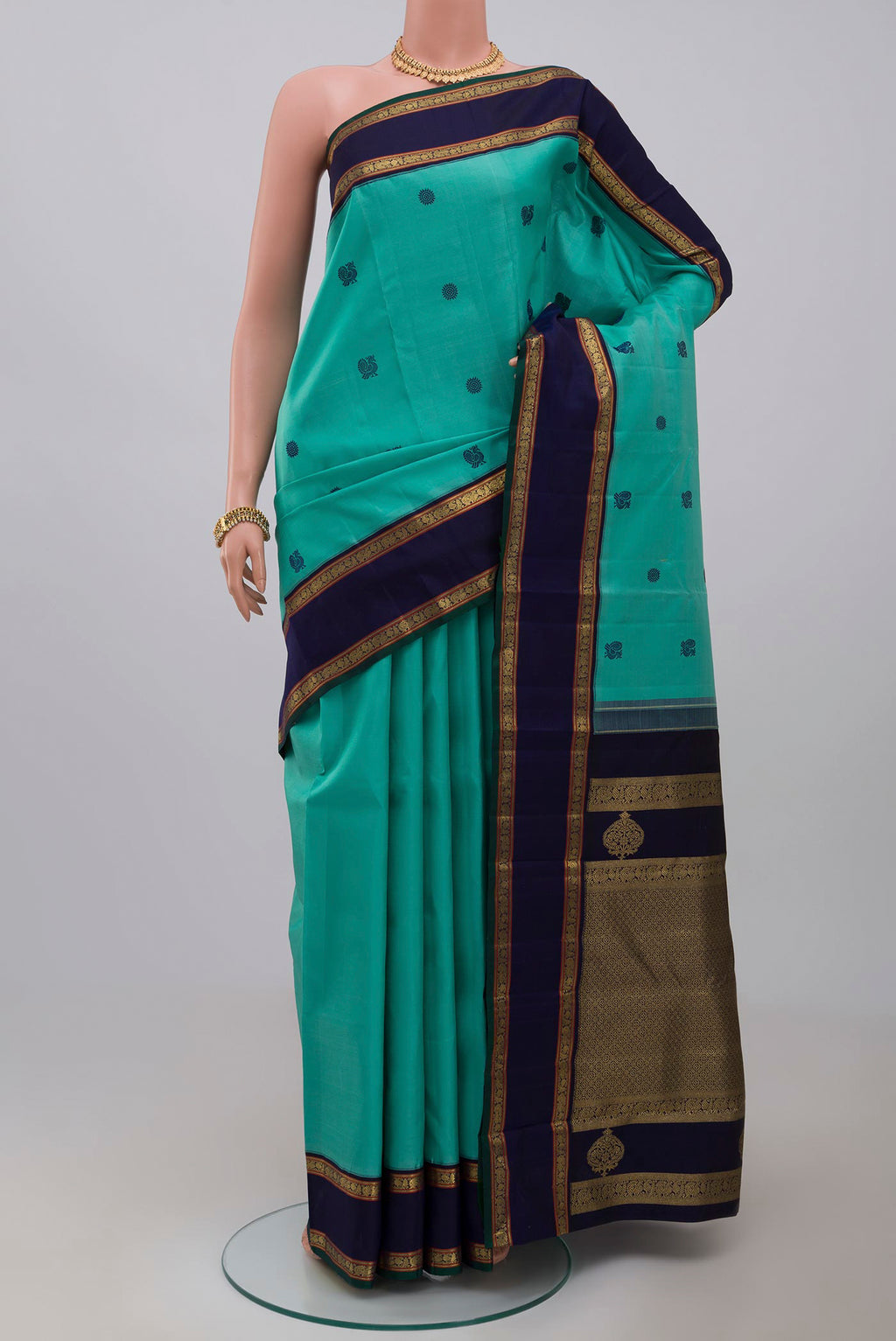 Pure Silk Pure Zari Light Blue Kanchipuram Saree with Thread Butta on the body and Zari Border.  displayed on a mannequin